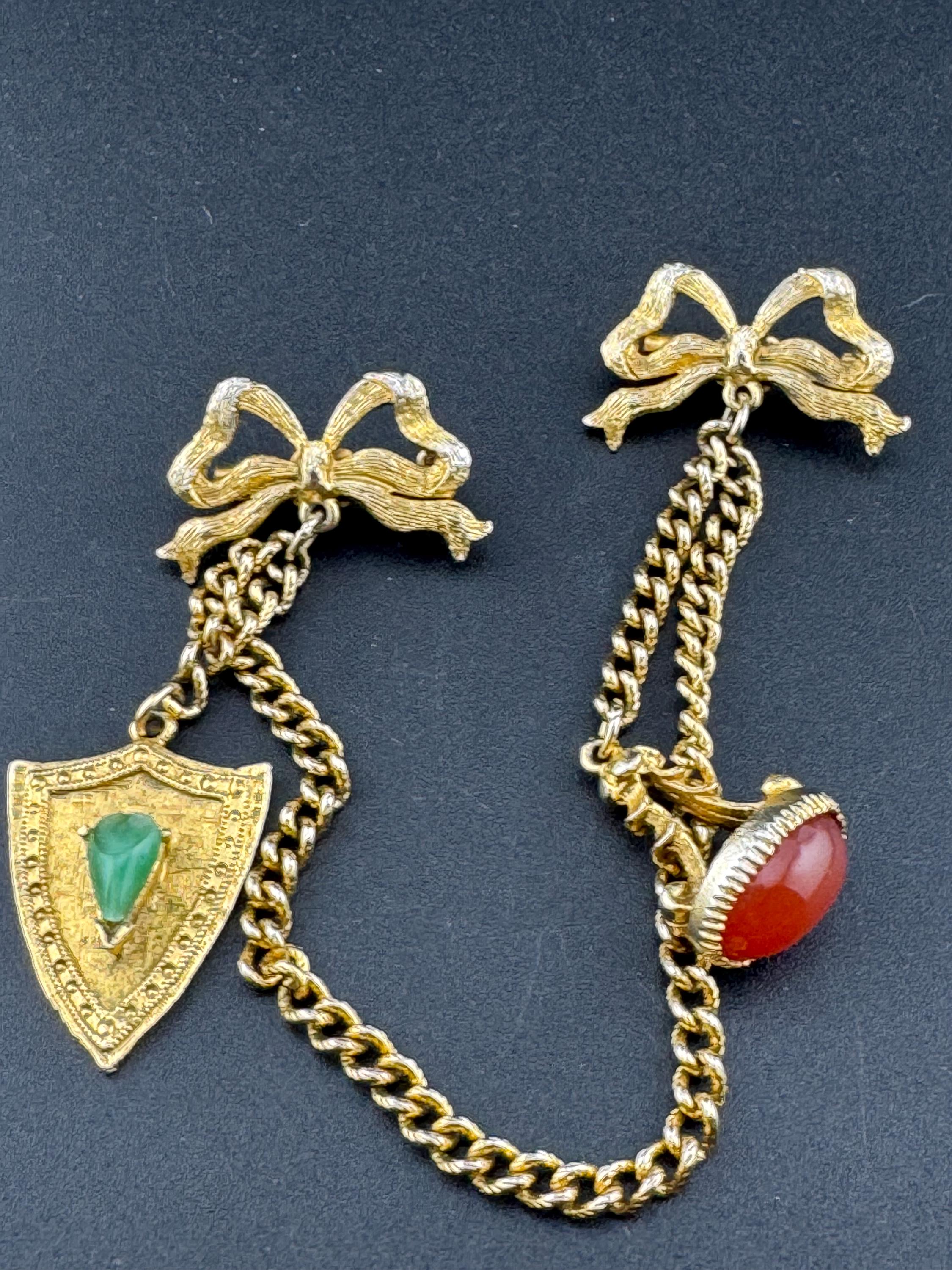 vintage double brooch gold tone with green gem set shield and faux carnelian cabochon jumper guards cloak clips
