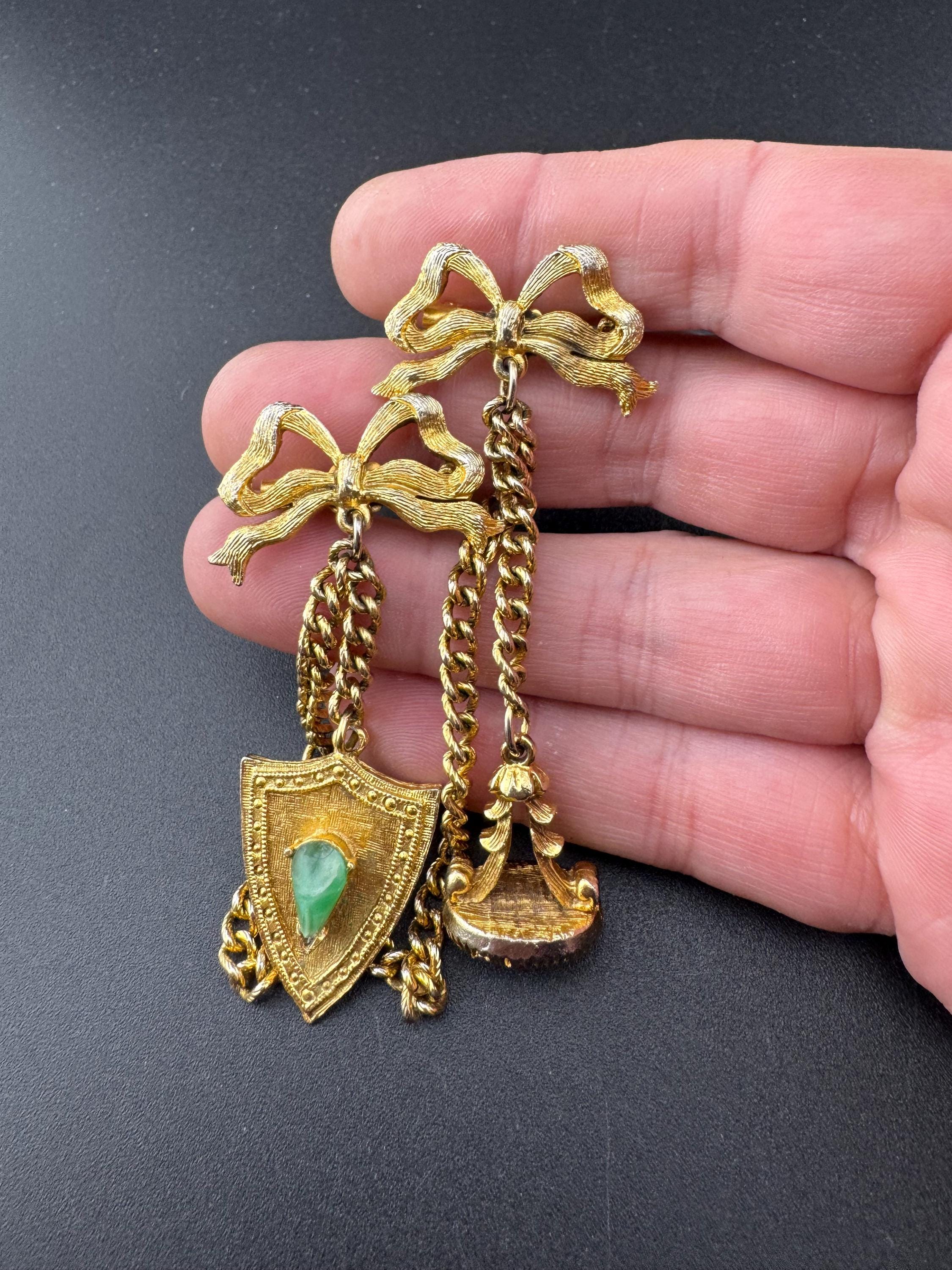 vintage double brooch gold tone with green gem set shield and faux carnelian cabochon jumper guards cloak clips