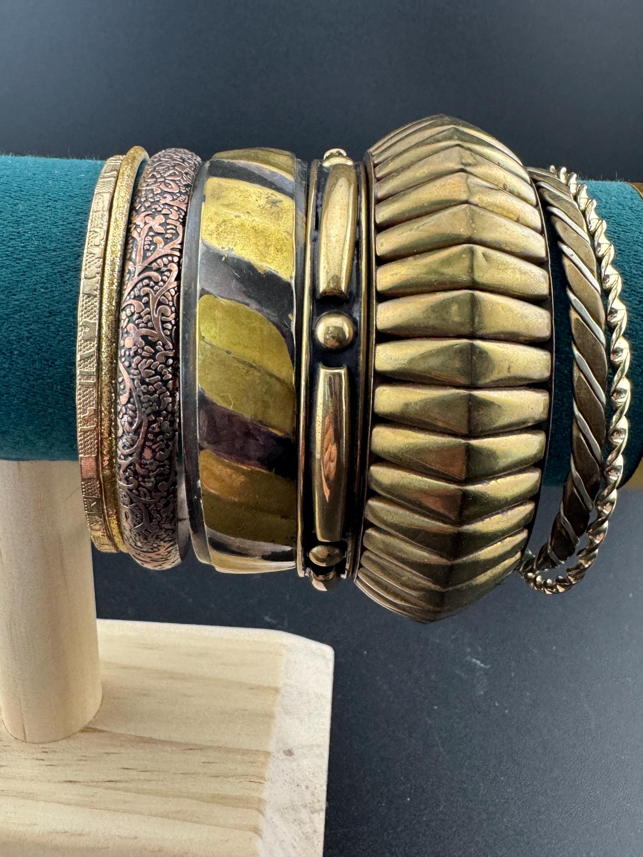 A curated set of vintage and retro gold tones stacking bangles,  boho festival bracelets