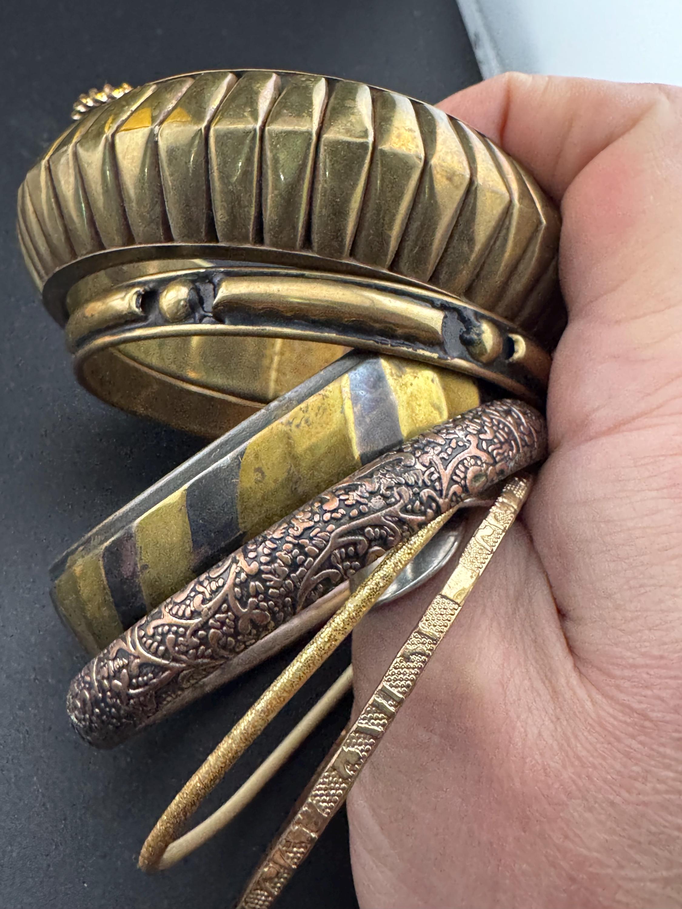 A curated set of vintage and retro gold tones stacking bangles,  boho festival bracelets