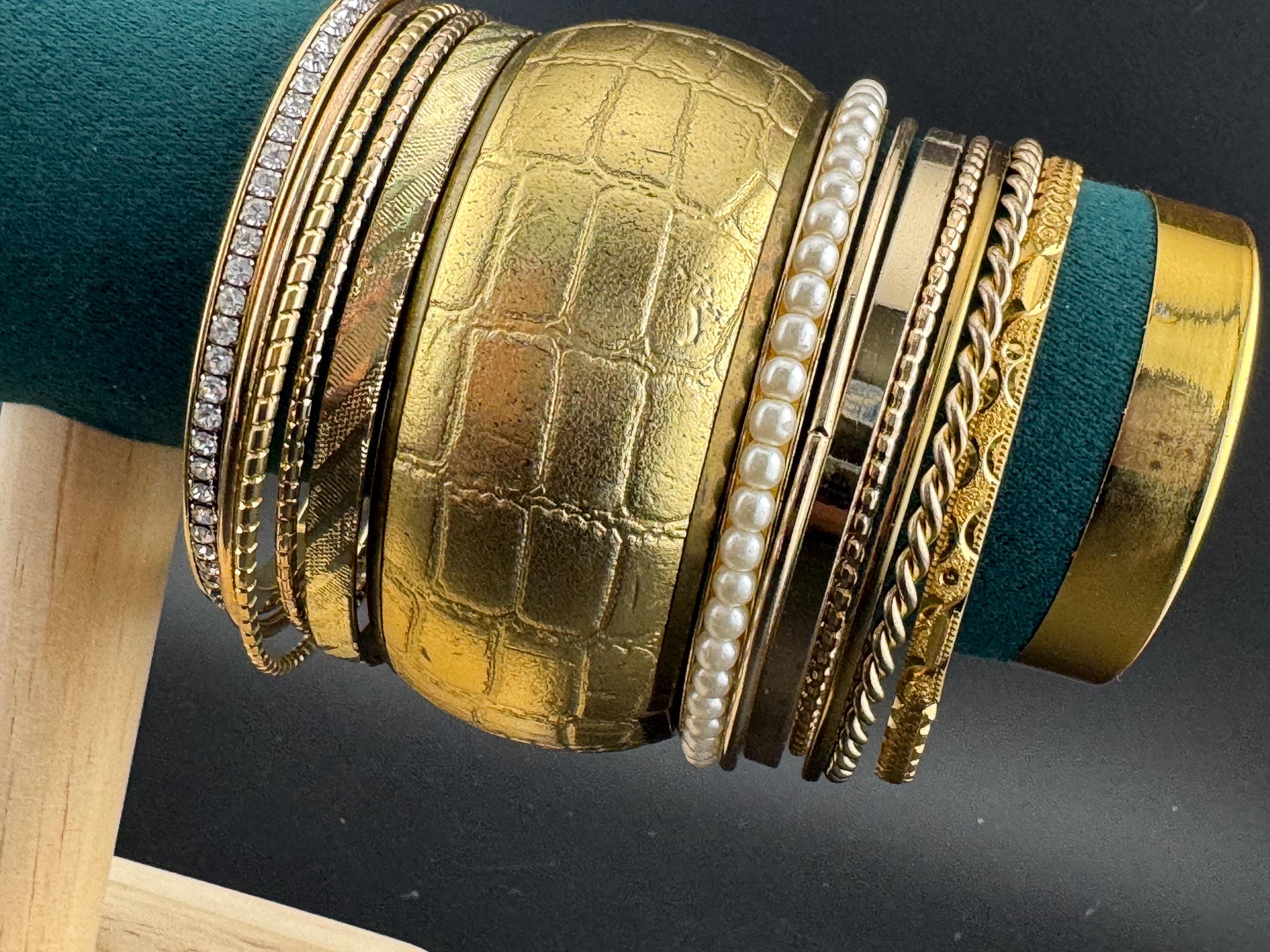 A curated set of vintage and retro gold tones stacking bangles,  boho festival bracelets