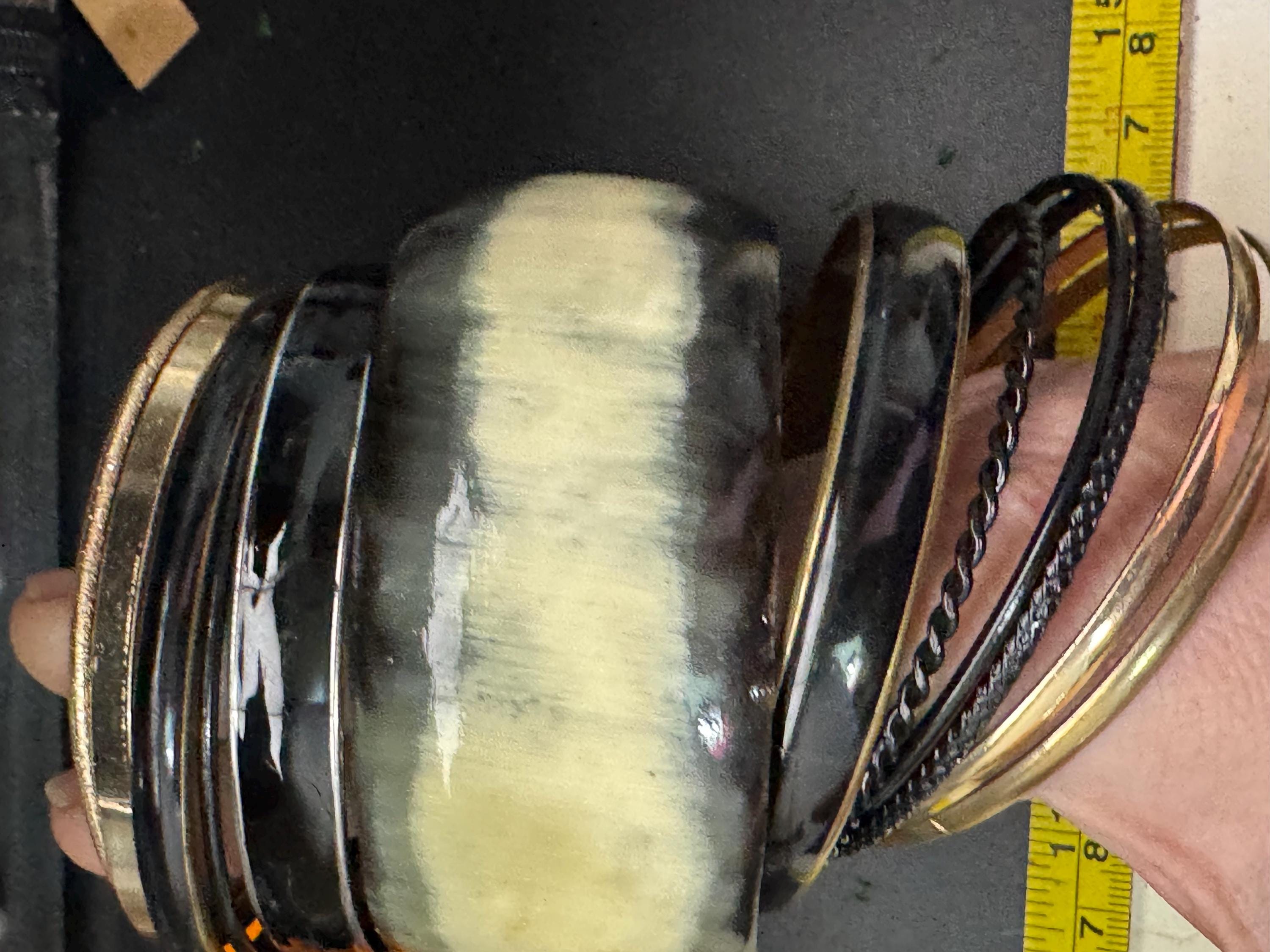 A curated set of vintage and retro gold black tones stacking bangles,  boho festival bracelets