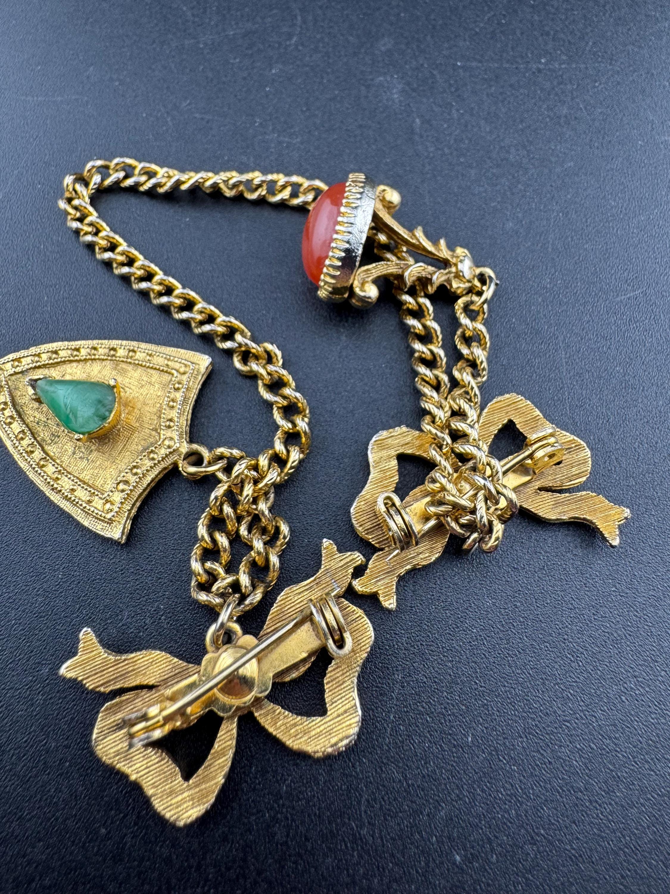 vintage double brooch gold tone with green gem set shield and faux carnelian cabochon jumper guards cloak clips