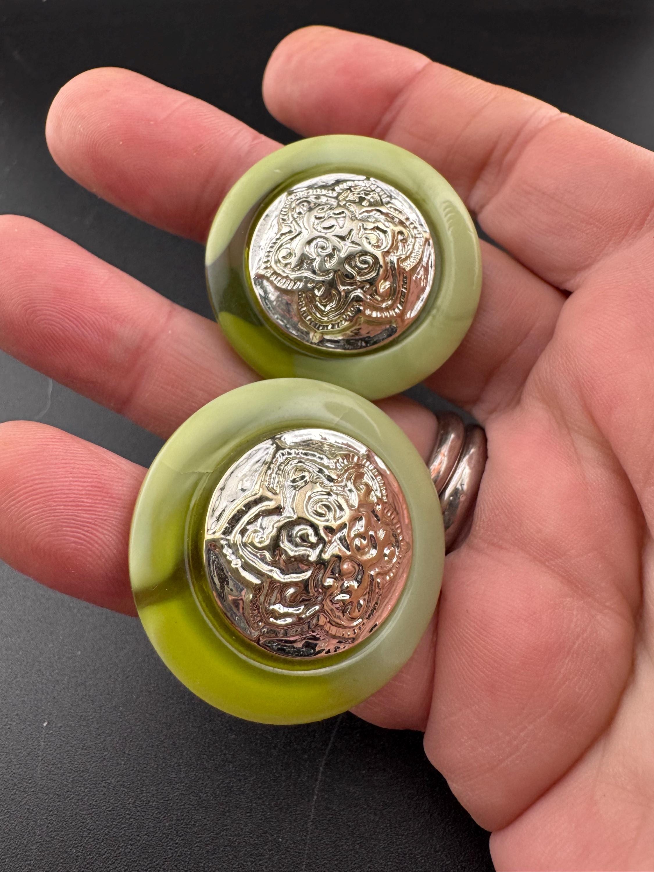 Oversized green plastic disc pierced earrings with silver tone embossed centre, big studs