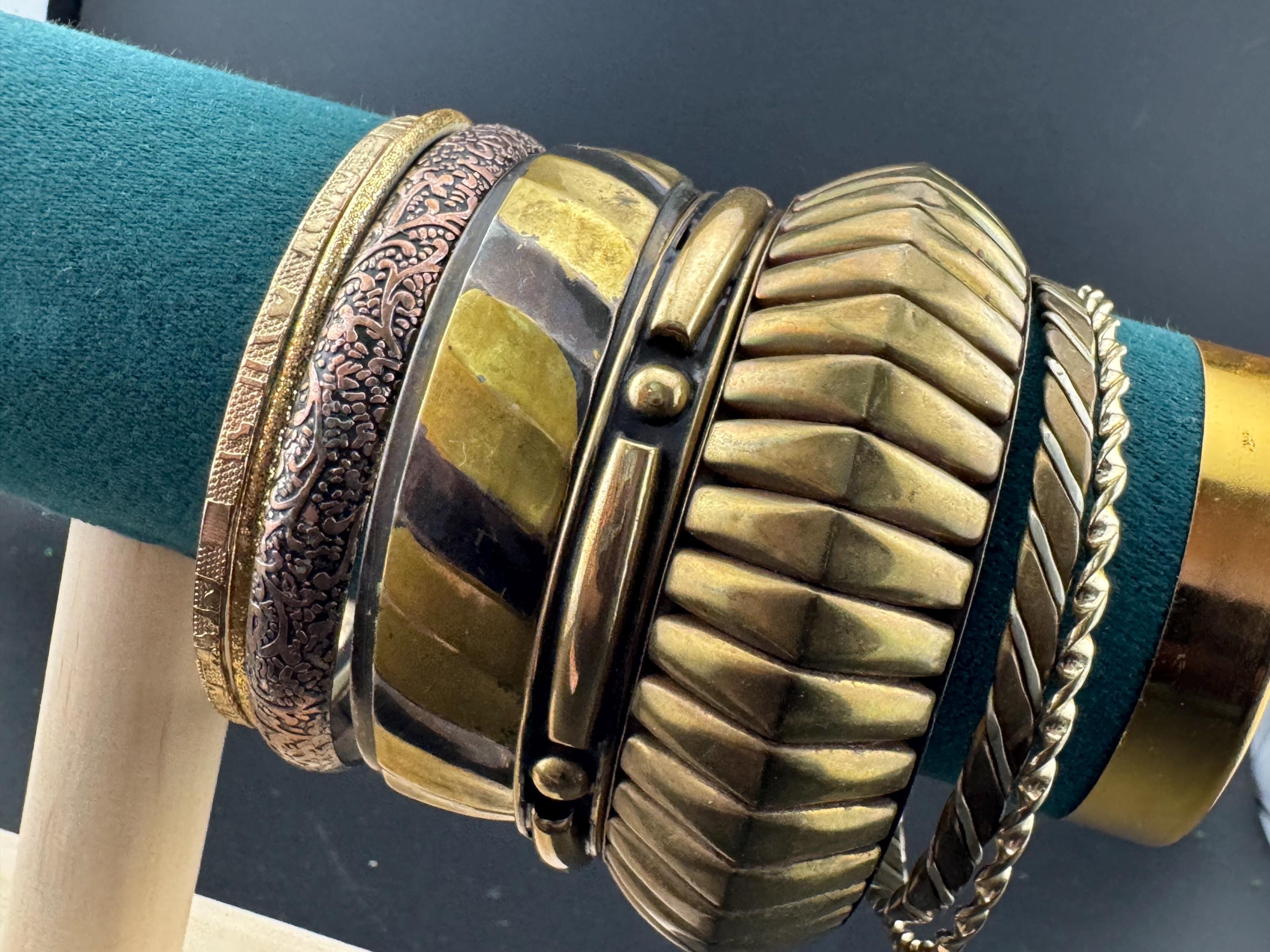 A curated set of vintage and retro gold tones stacking bangles,  boho festival bracelets