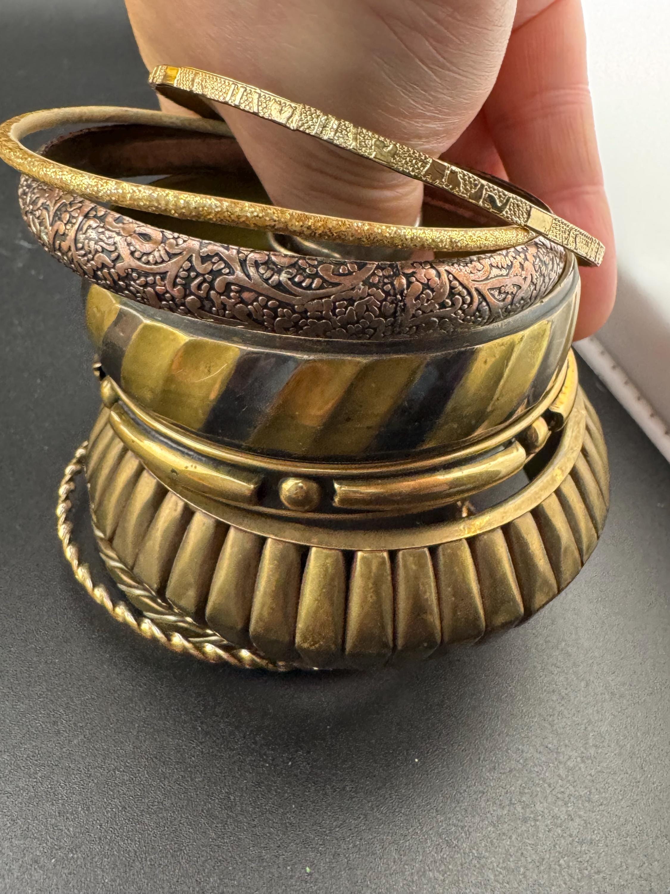 A curated set of vintage and retro gold tones stacking bangles,  boho festival bracelets