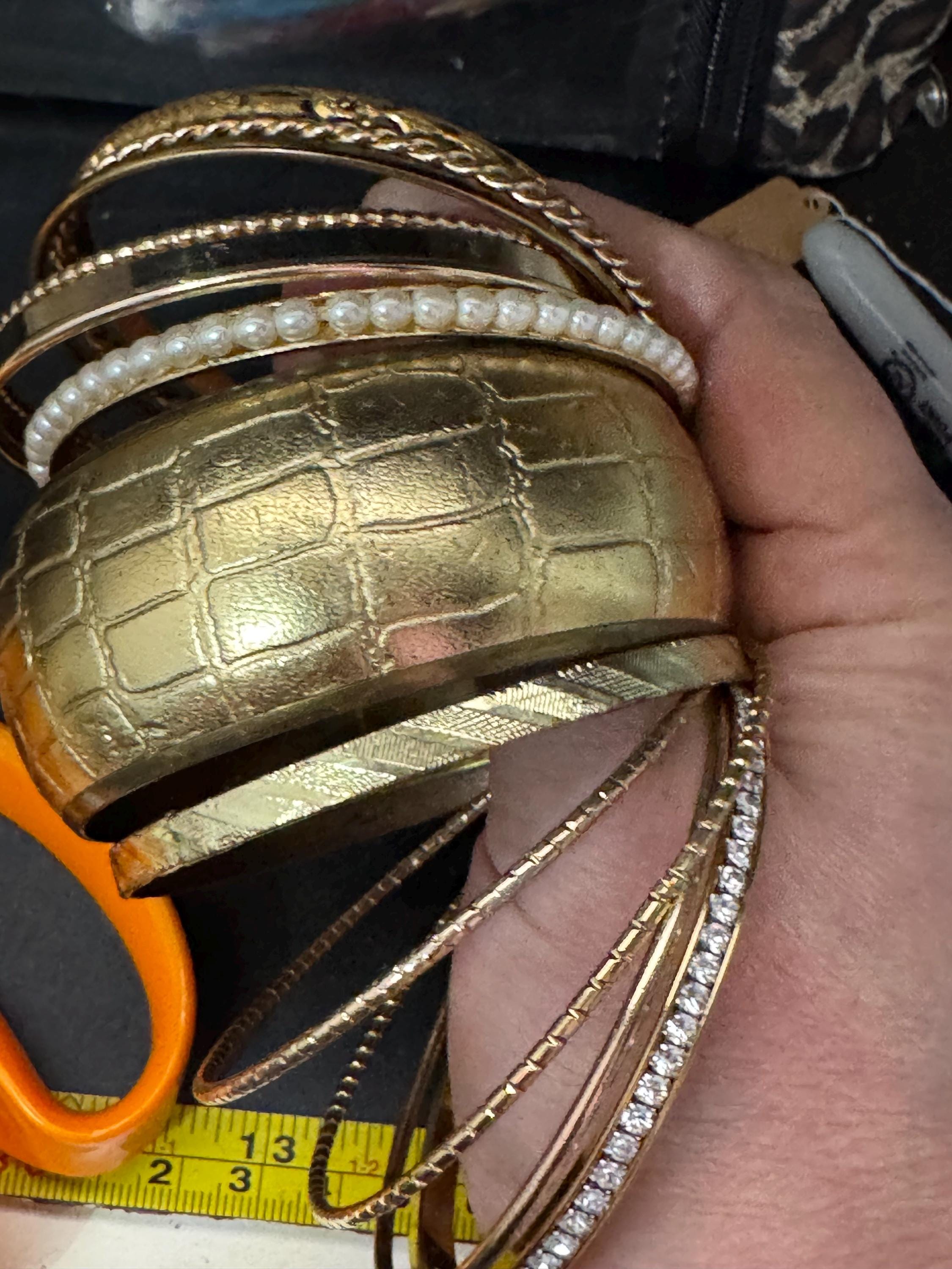 A curated set of vintage and retro gold tones stacking bangles,  boho festival bracelets