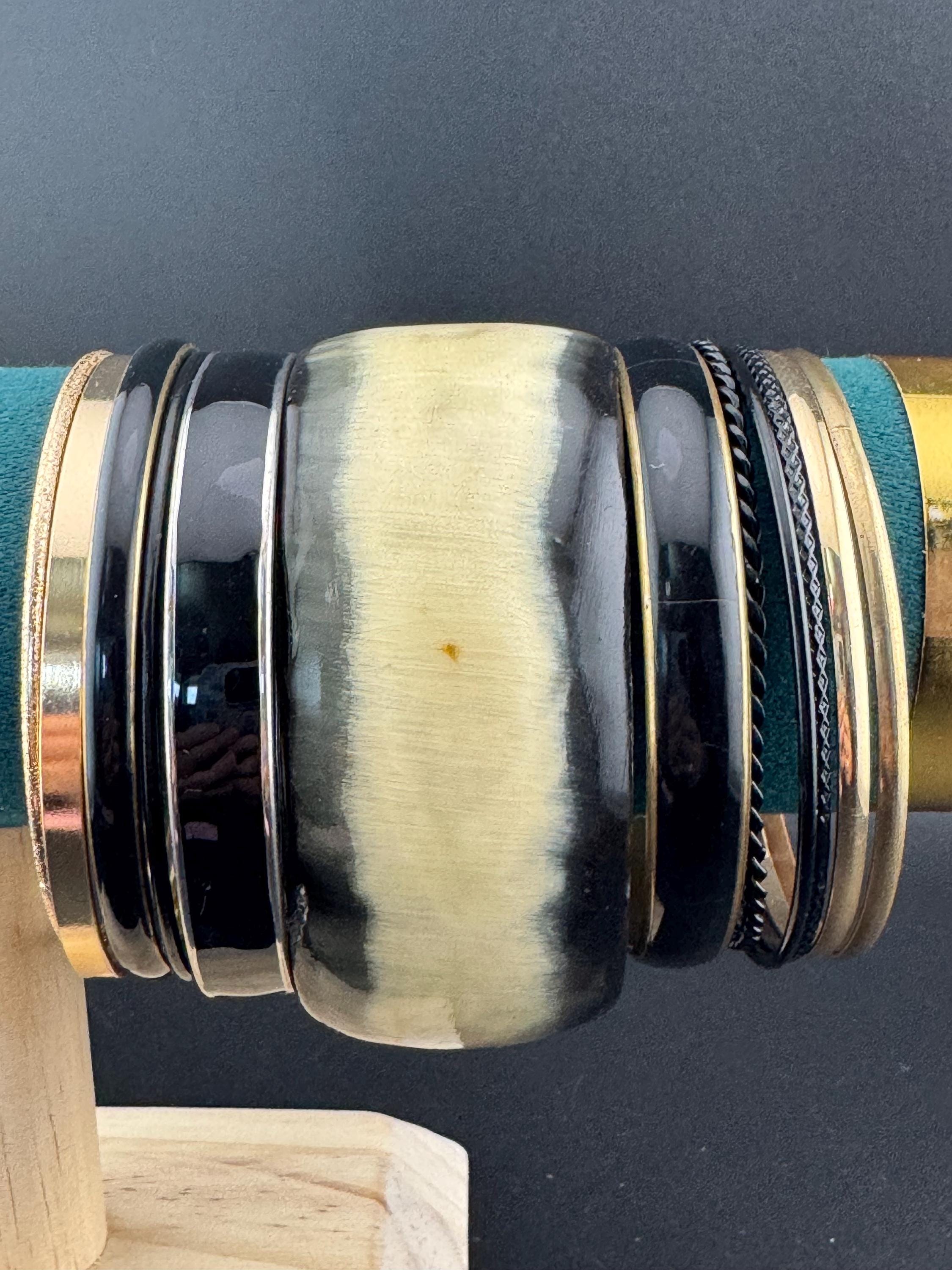 A curated set of vintage and retro gold black tones stacking bangles,  boho festival bracelets