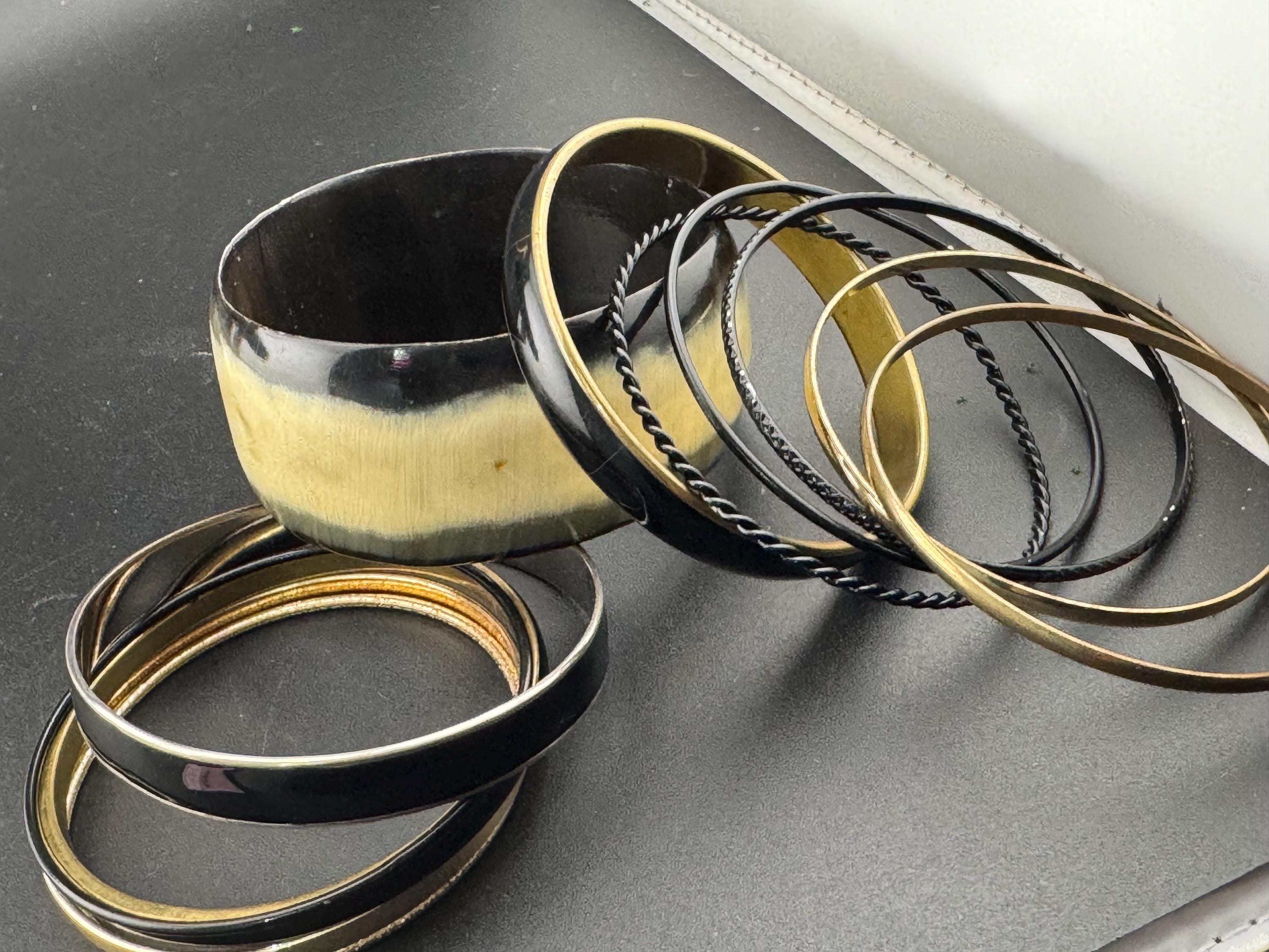 A curated set of vintage and retro gold black tones stacking bangles,  boho festival bracelets