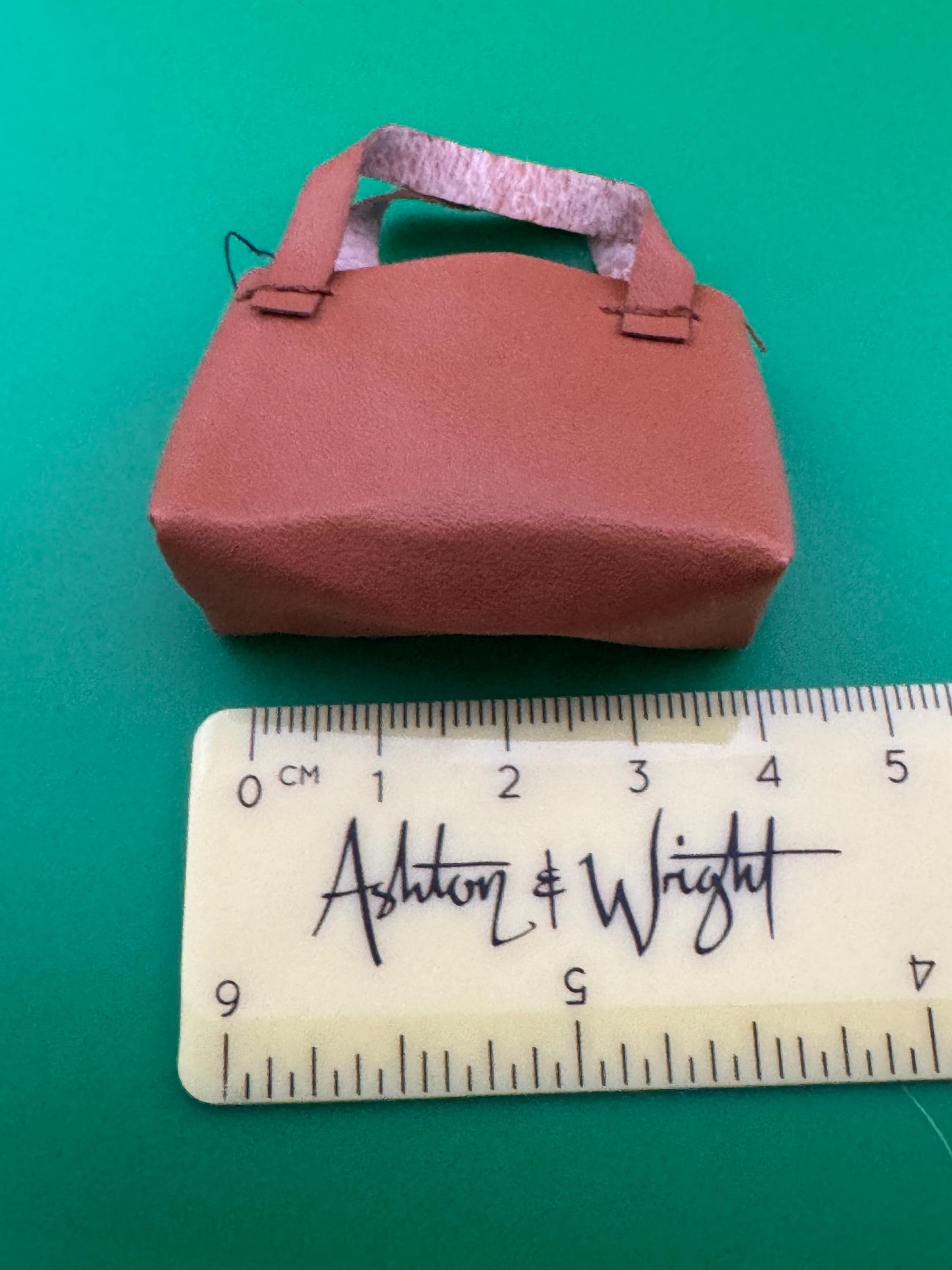 miniature brown tote handbag cake topper decoration for a dolls cake