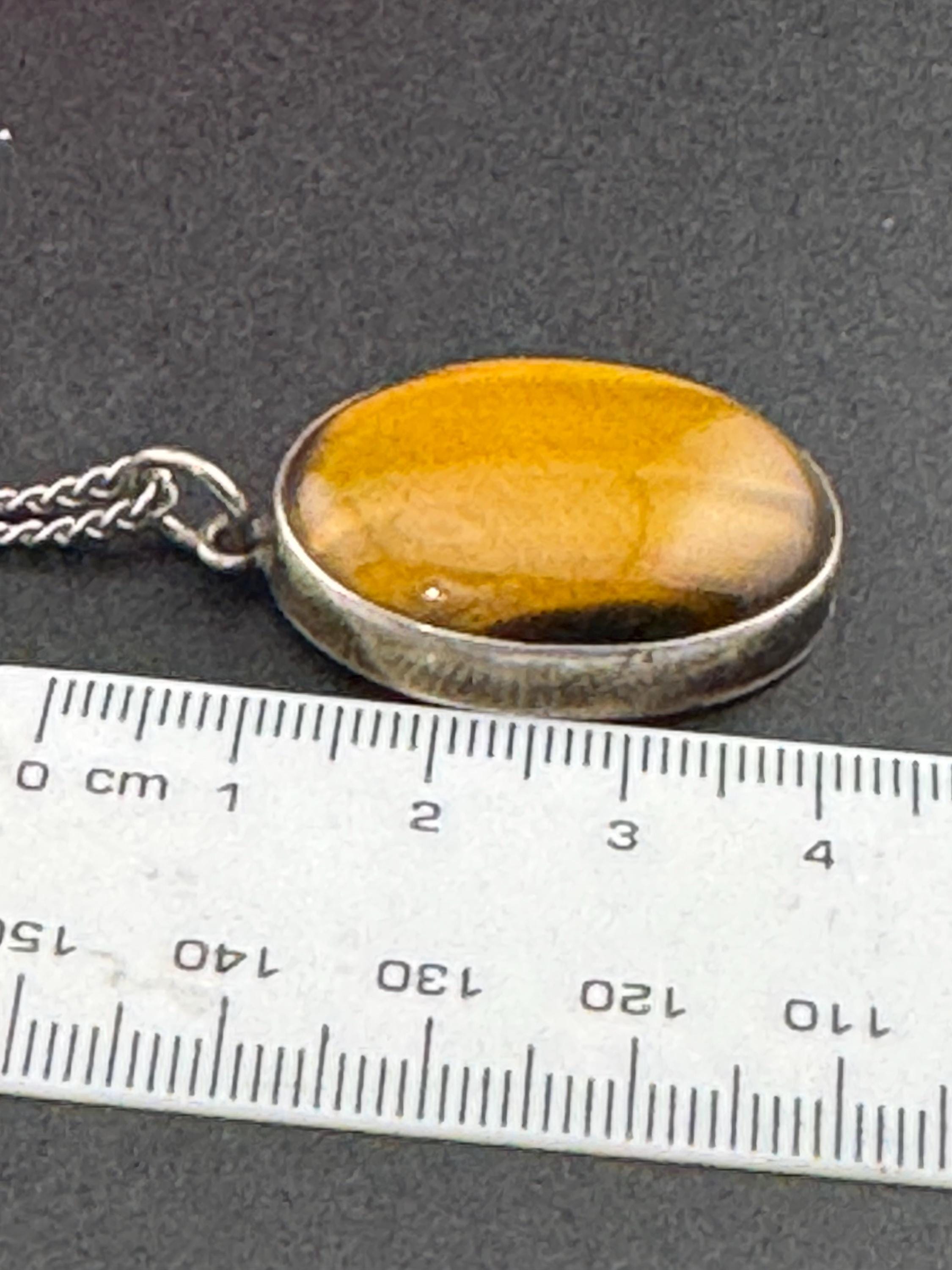 Solid silver tigerseye oval gemstone pendant necklace on 54cm chain 1970s weighs 13.7 grams
