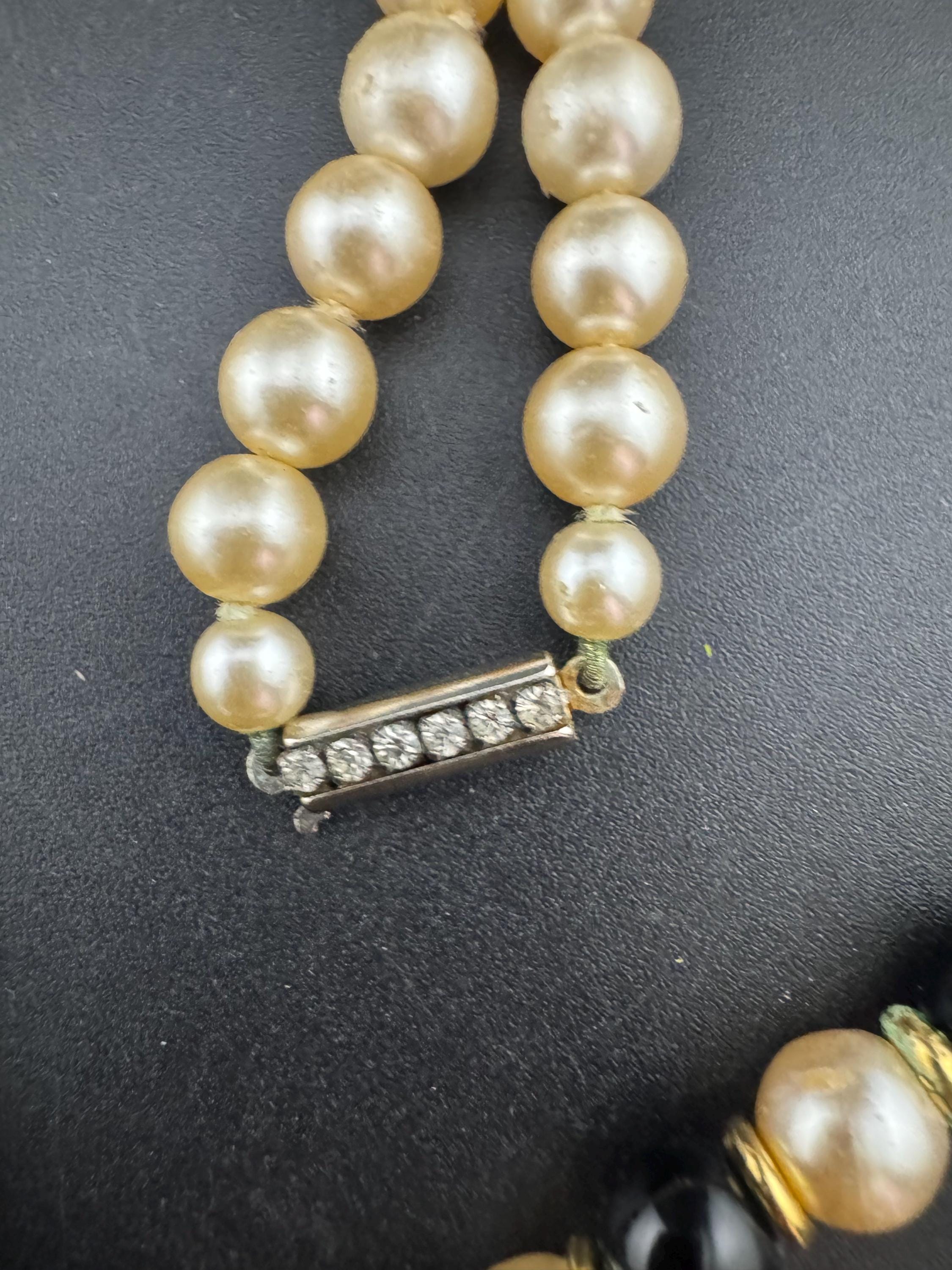 Signed Sphinx cream glass beaded diamanté necklace with classic black ribbon bow detail