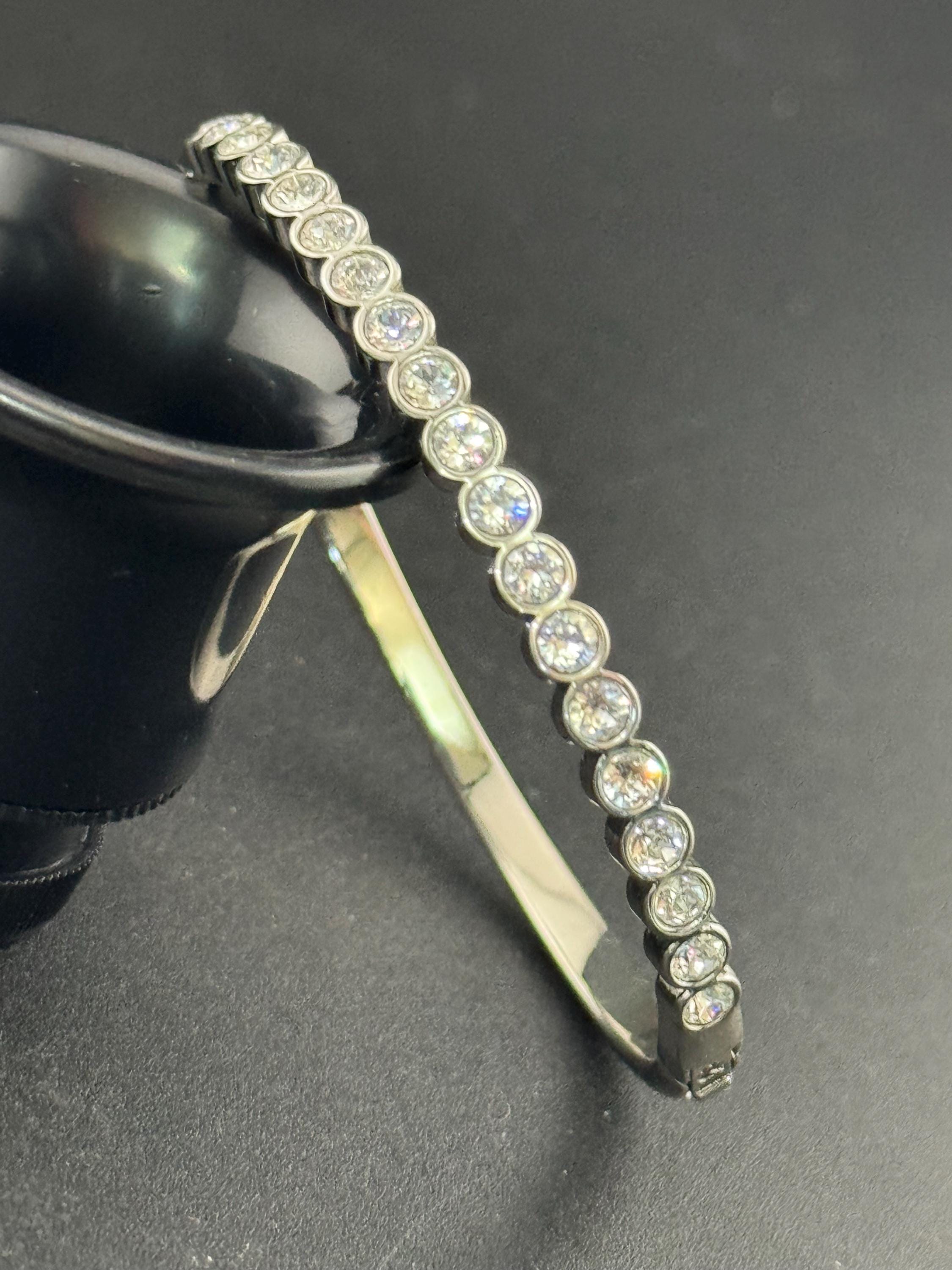 Vintage slim silver tone hinged bangle bracelet with clear glass bezel set rhinestones crystals, signed