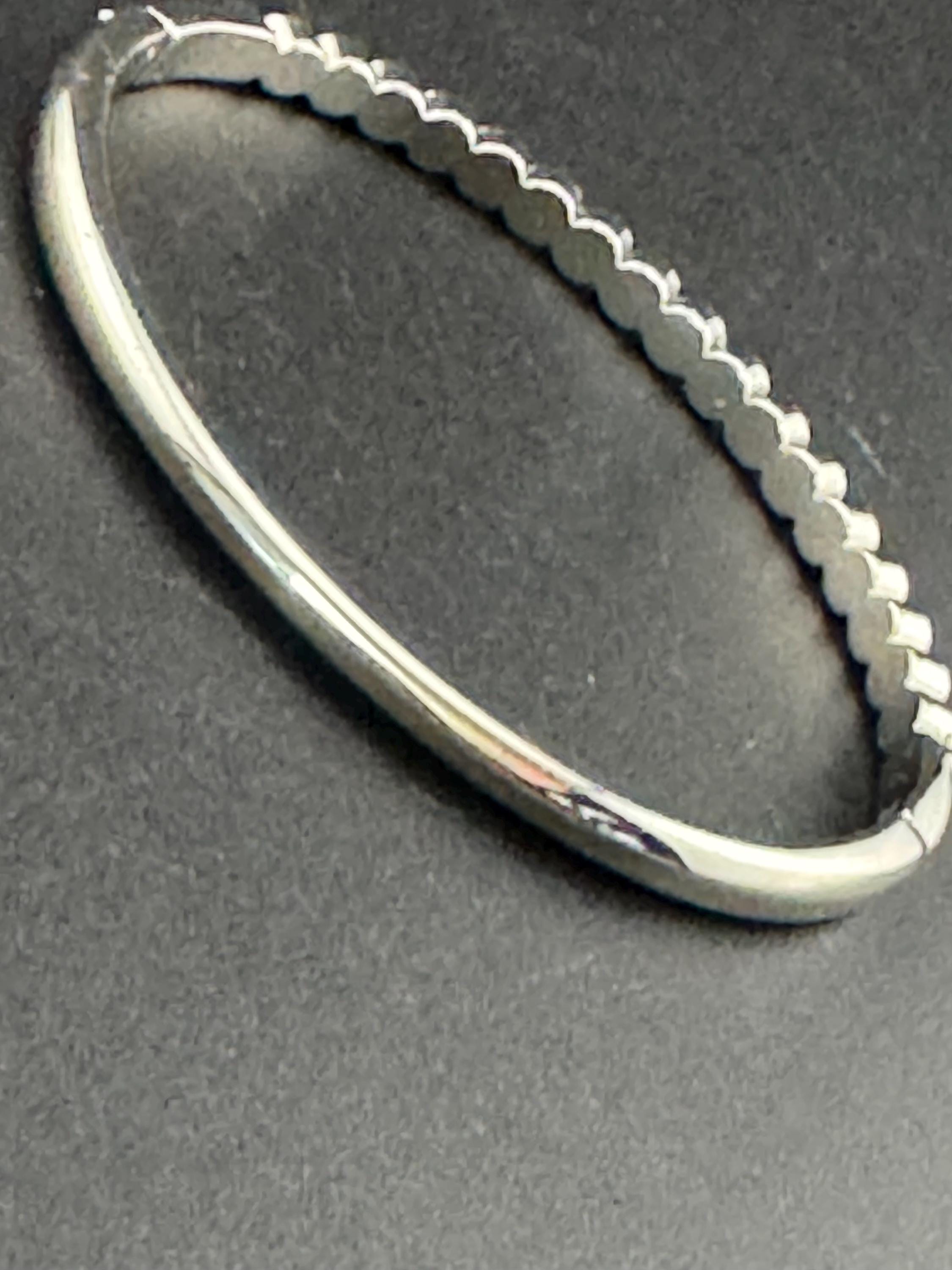 Vintage slim silver tone hinged bangle bracelet with clear glass bezel set rhinestones crystals, signed