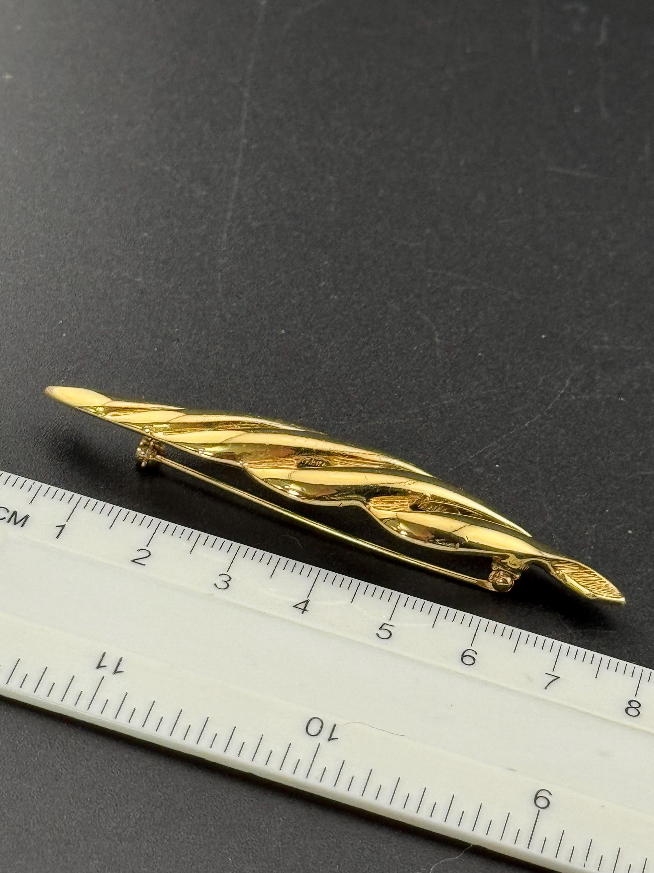 Signed MONET long 8cm gold tone abstract swirl brooch