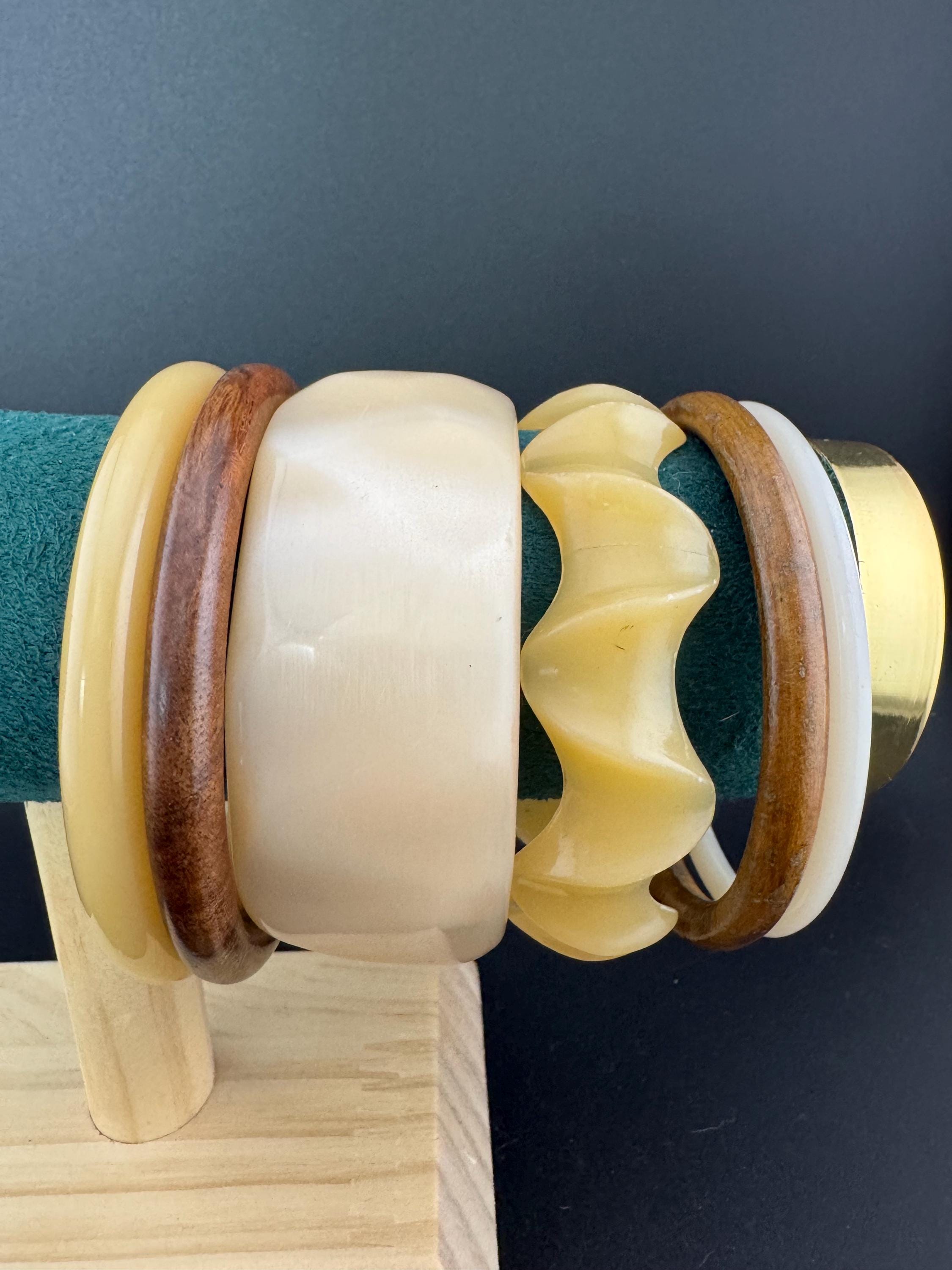 A curated stack of Cream brown beige neutrals vintage and retro plastic wooden bangles