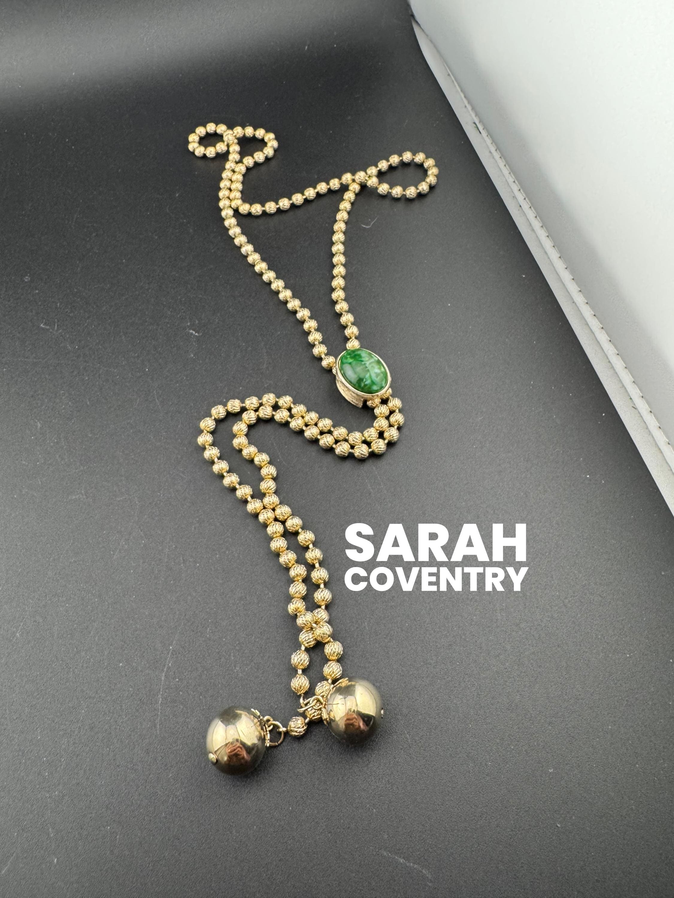 Signed Sarah Coventry gold tone ball bead chain drop tassel bolo necklace with green cabochon adjustable length