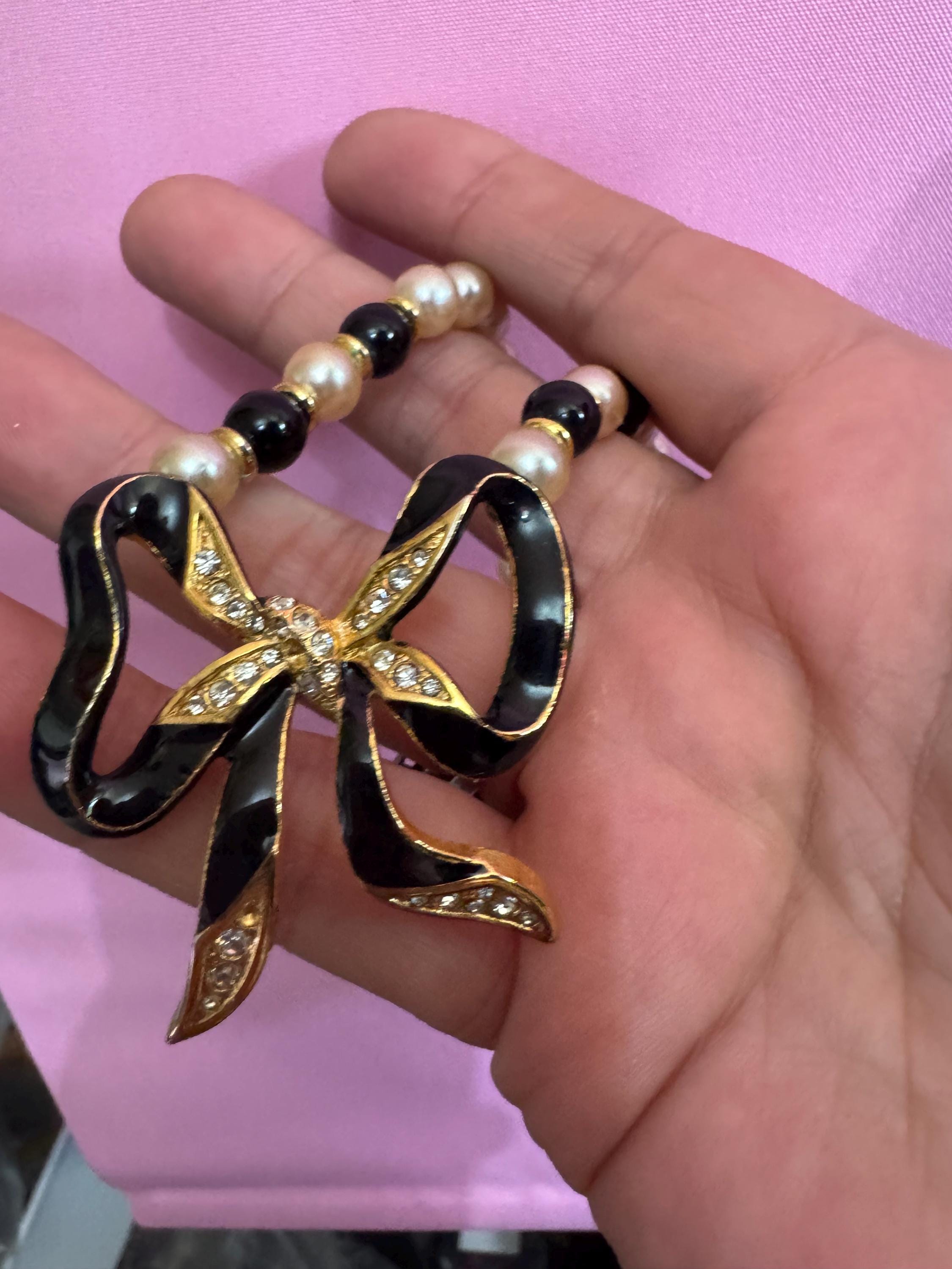 Signed Sphinx cream glass beaded diamanté necklace with classic black ribbon bow detail