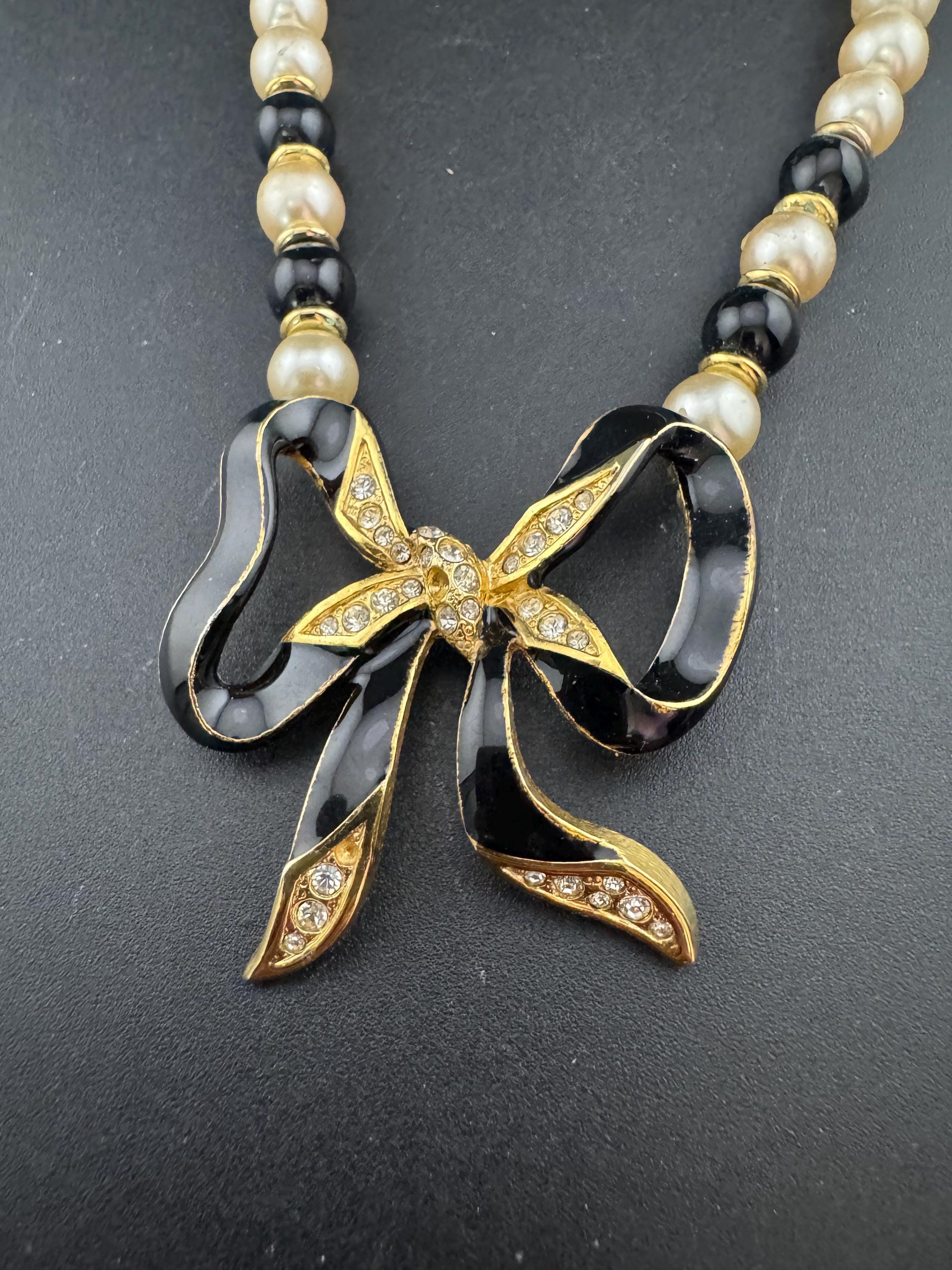 Signed Sphinx cream glass beaded diamanté necklace with classic black ribbon bow detail