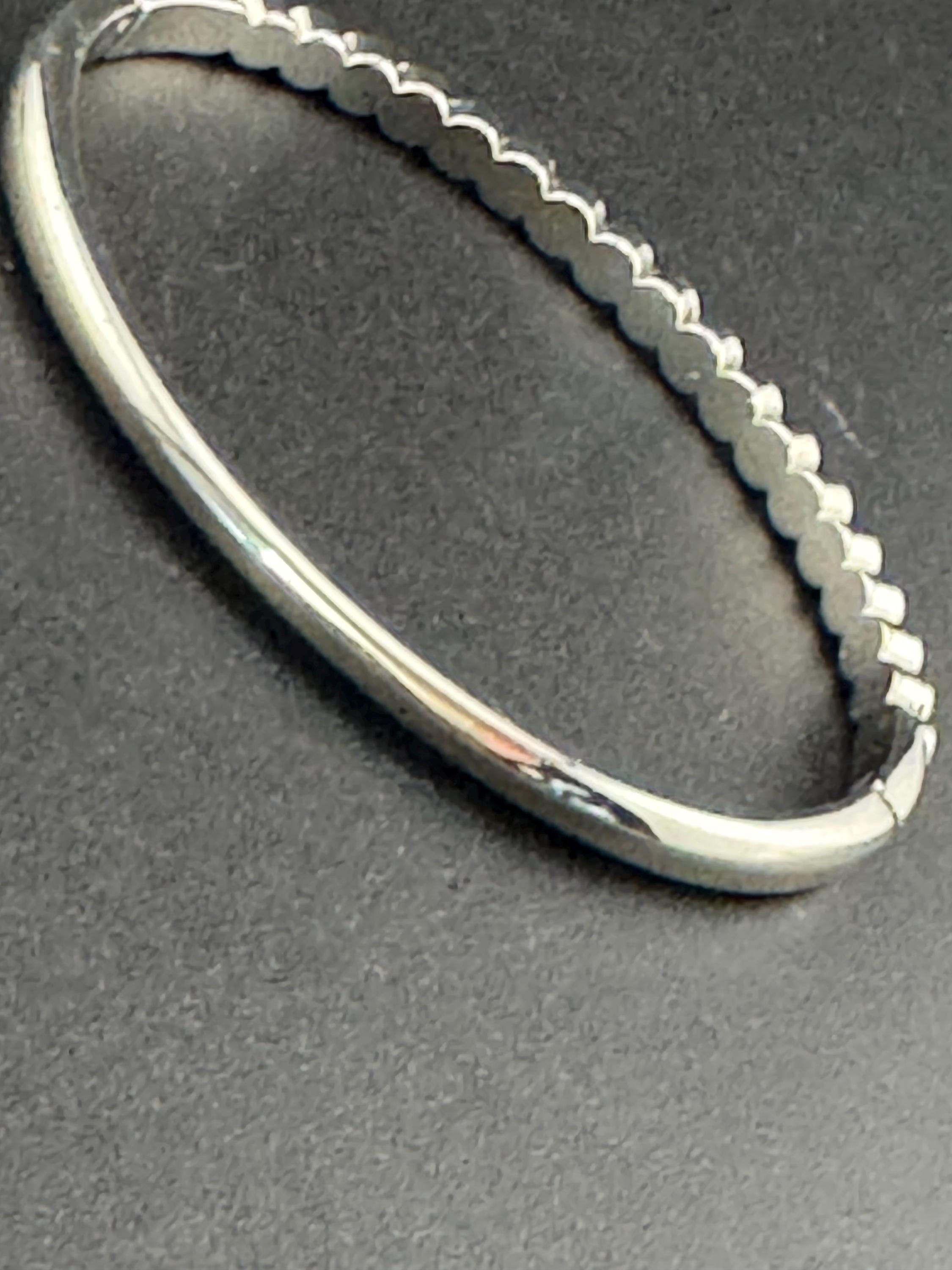 Vintage slim silver tone hinged bangle bracelet with clear glass bezel set rhinestones crystals, signed