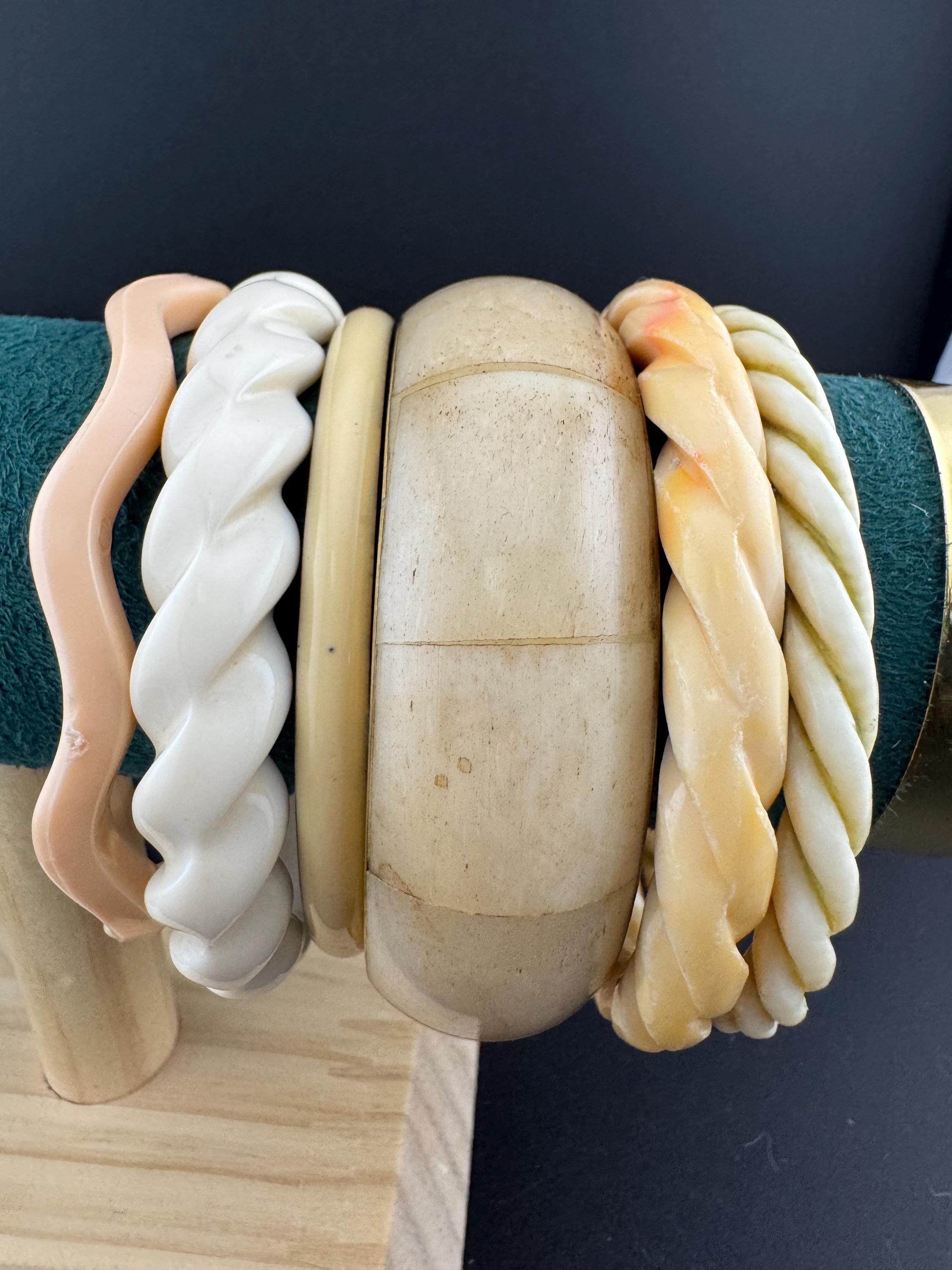 A curated stack of Cream pink beige neutrals vintage and retro plastic bangles