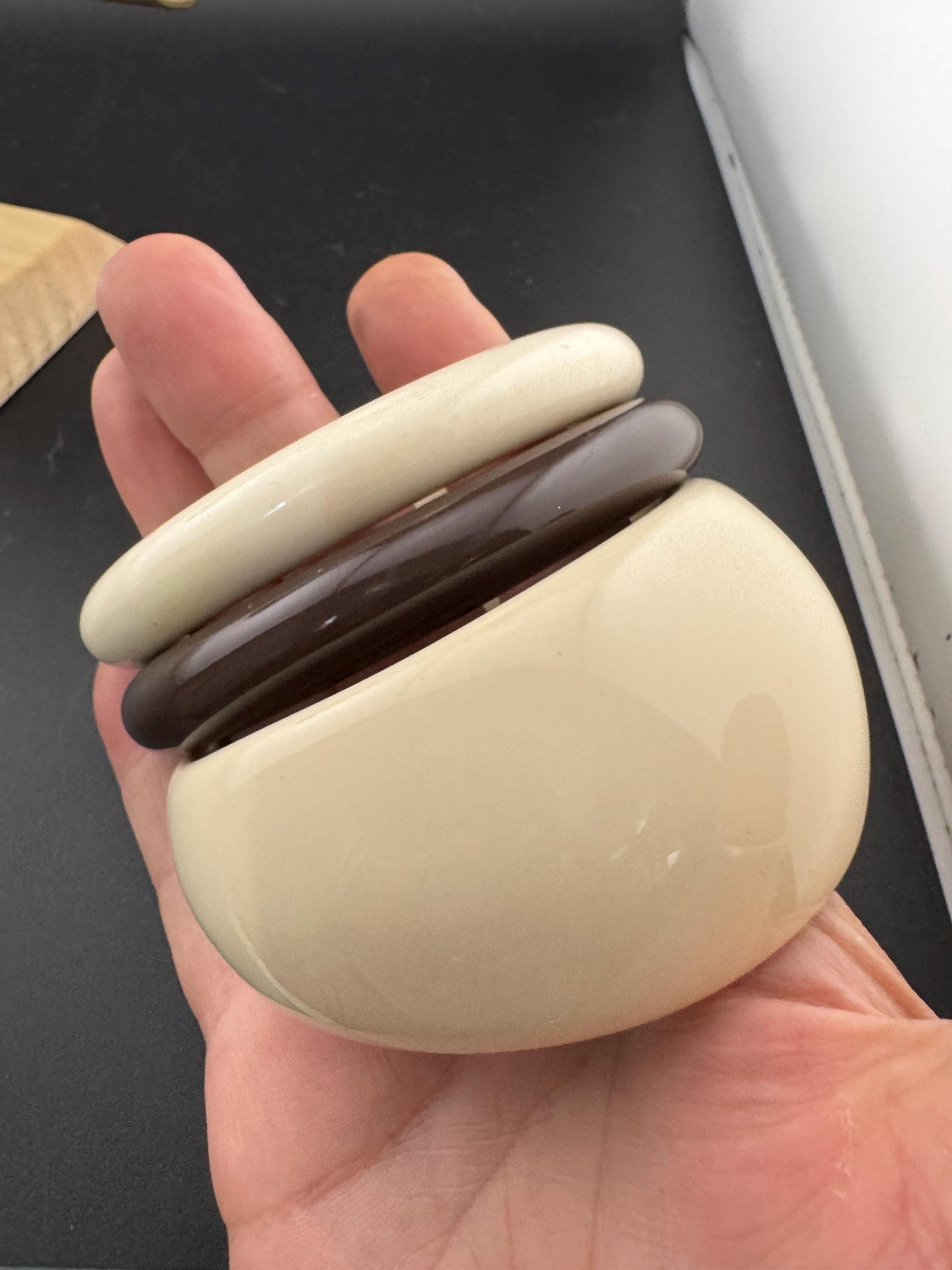 A curated stack of Cream brown beige neutrals vintage and retro plastic bangles