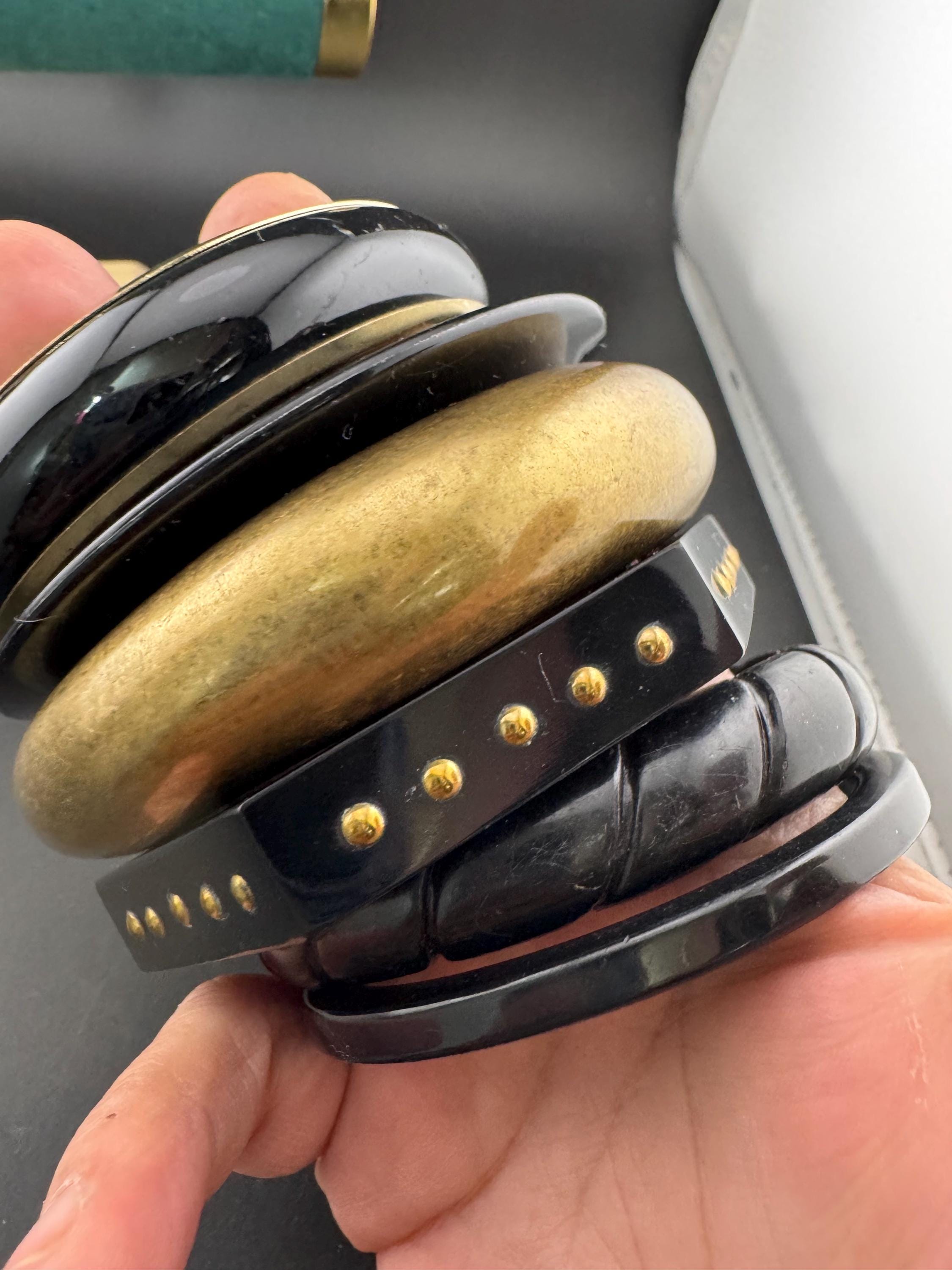 A curated set of vintage and retro gold black tones stacking bangles, boho festival bracelets