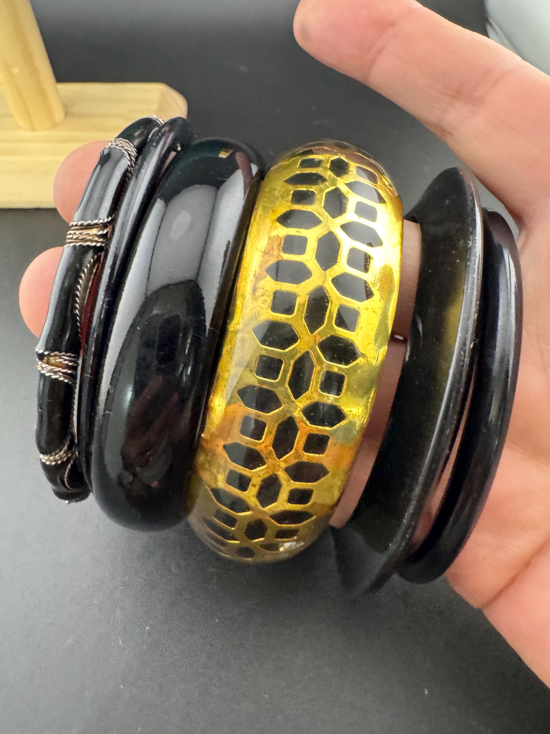 A curated set of vintage and retro gold black tones stacking bangles, boho festival bracelets