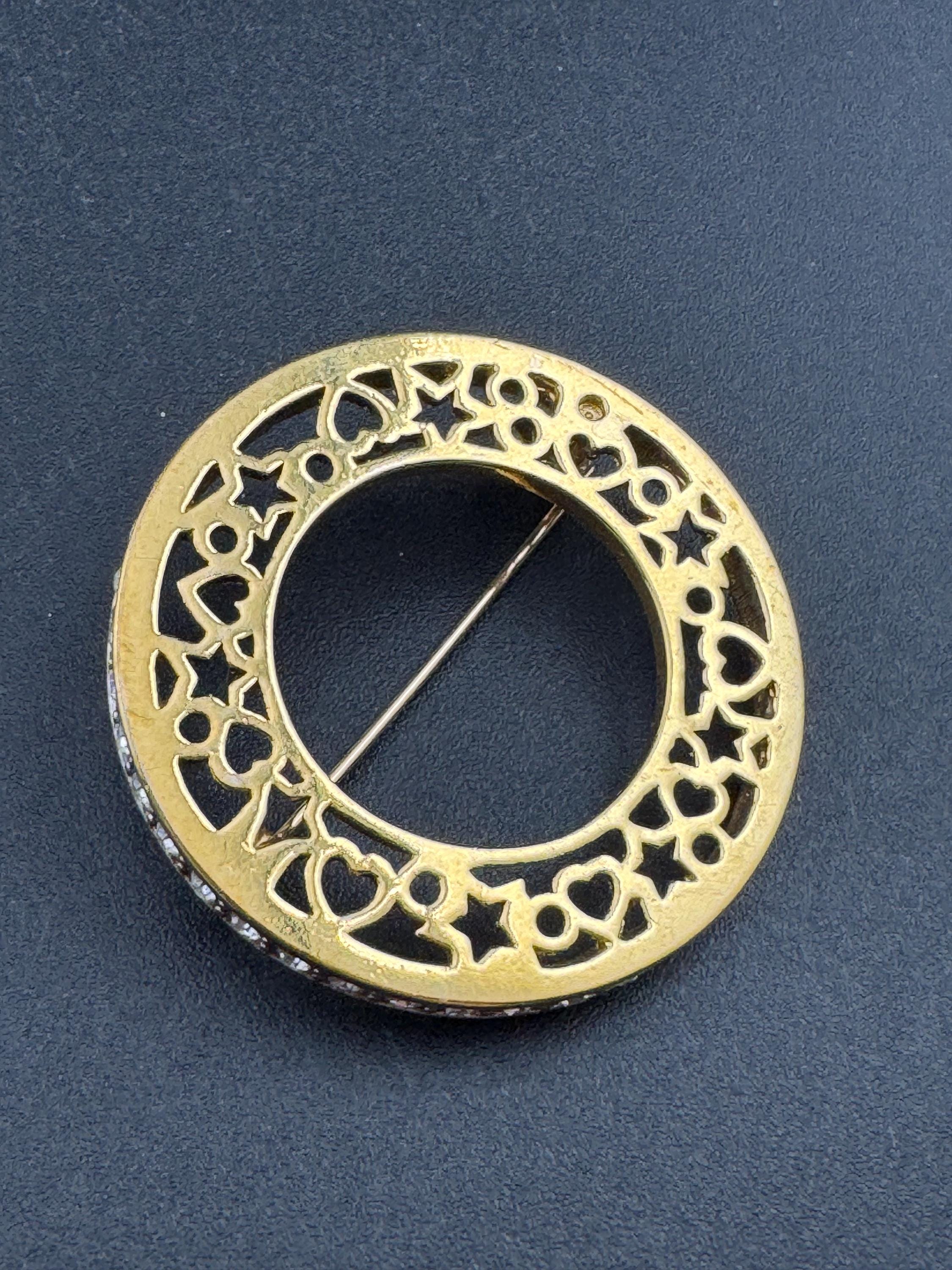 Vintage round openwork gold tone brooch channel set with clear rhinestones , sleek modernist design