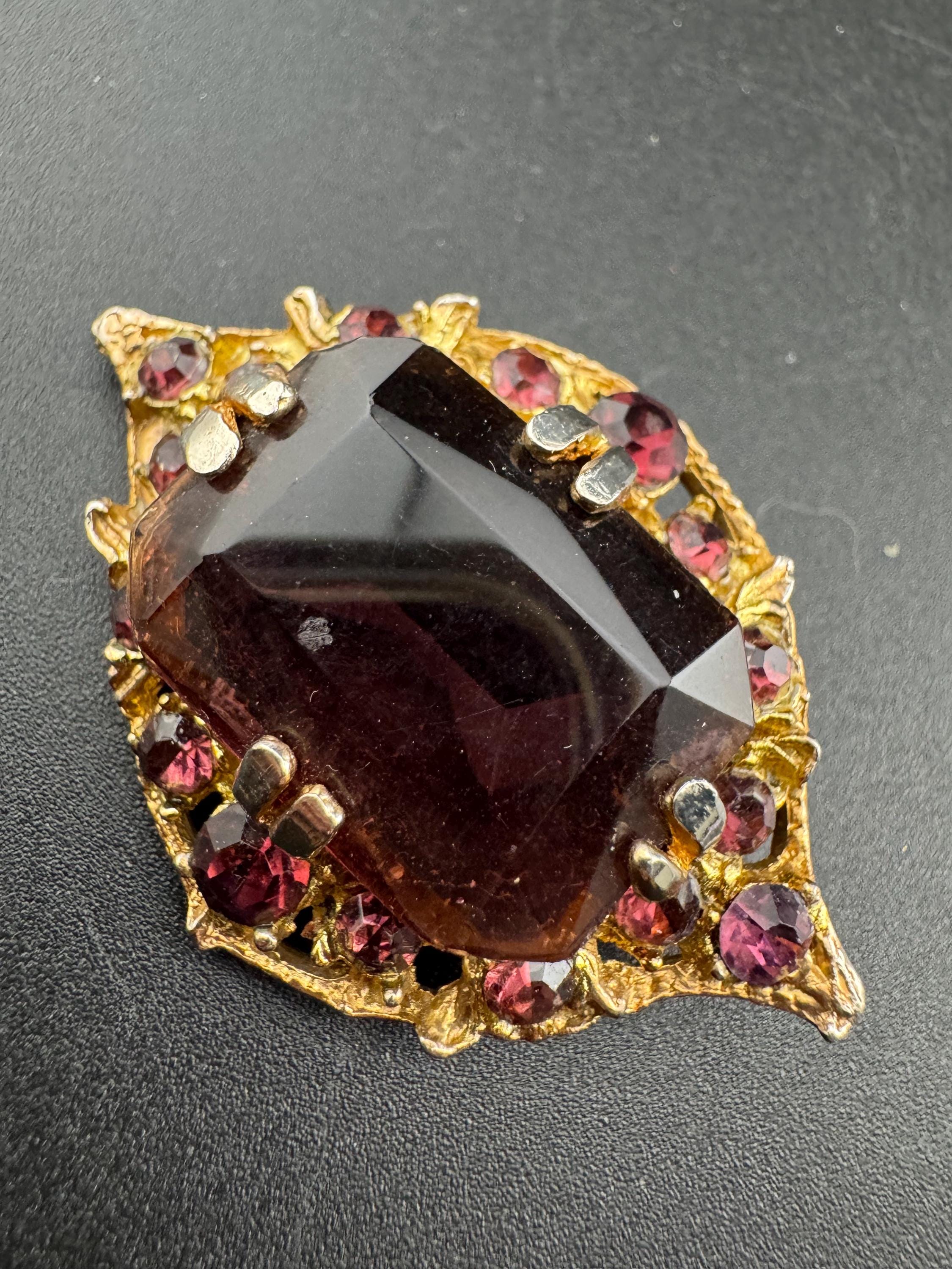 Chunky gold metal brooch with amethyst purple big central rhinestone glass diamanté cabochon