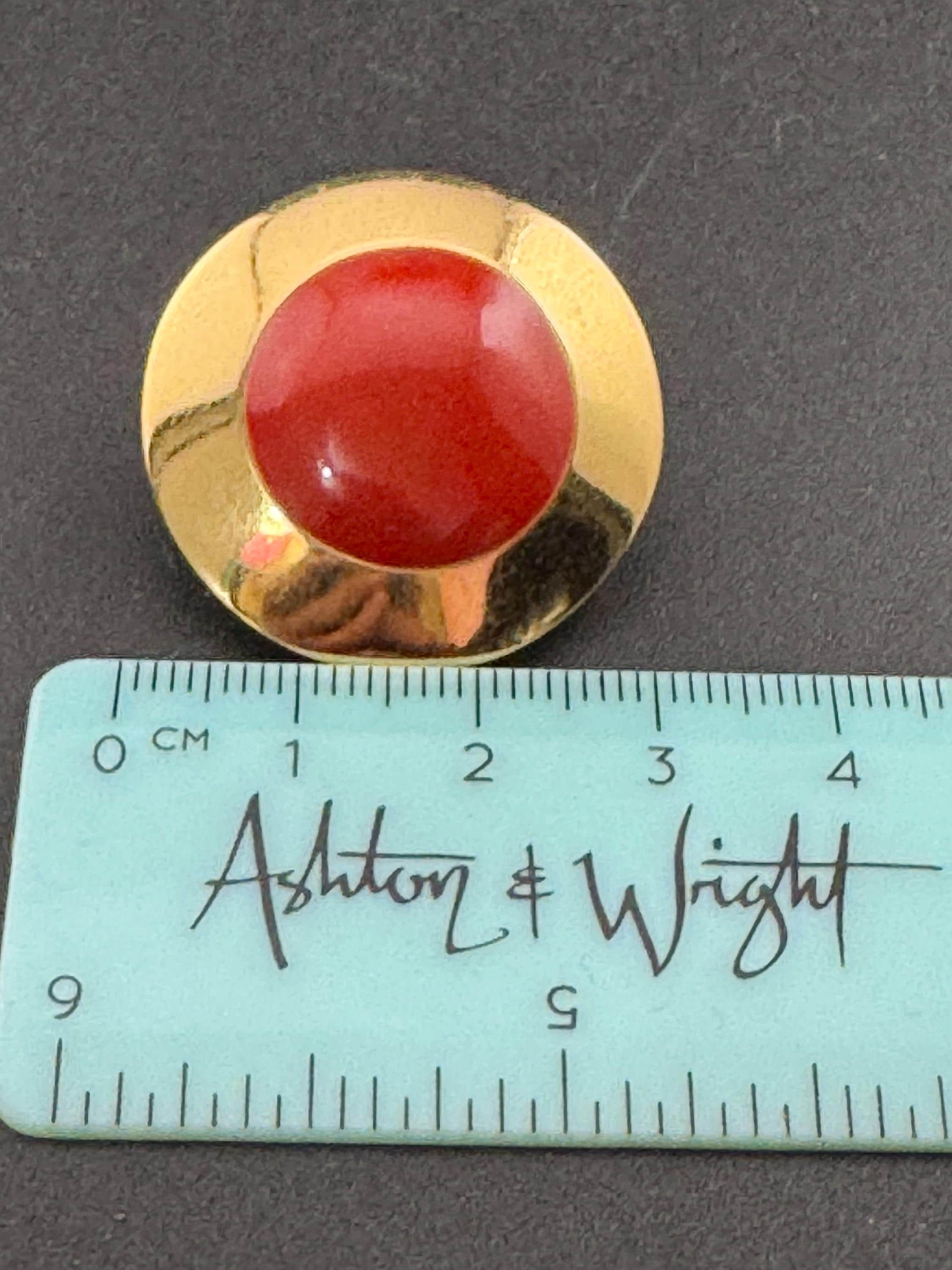 Signed MONET Gold tone deep red enamel low domed disc clip on earrings