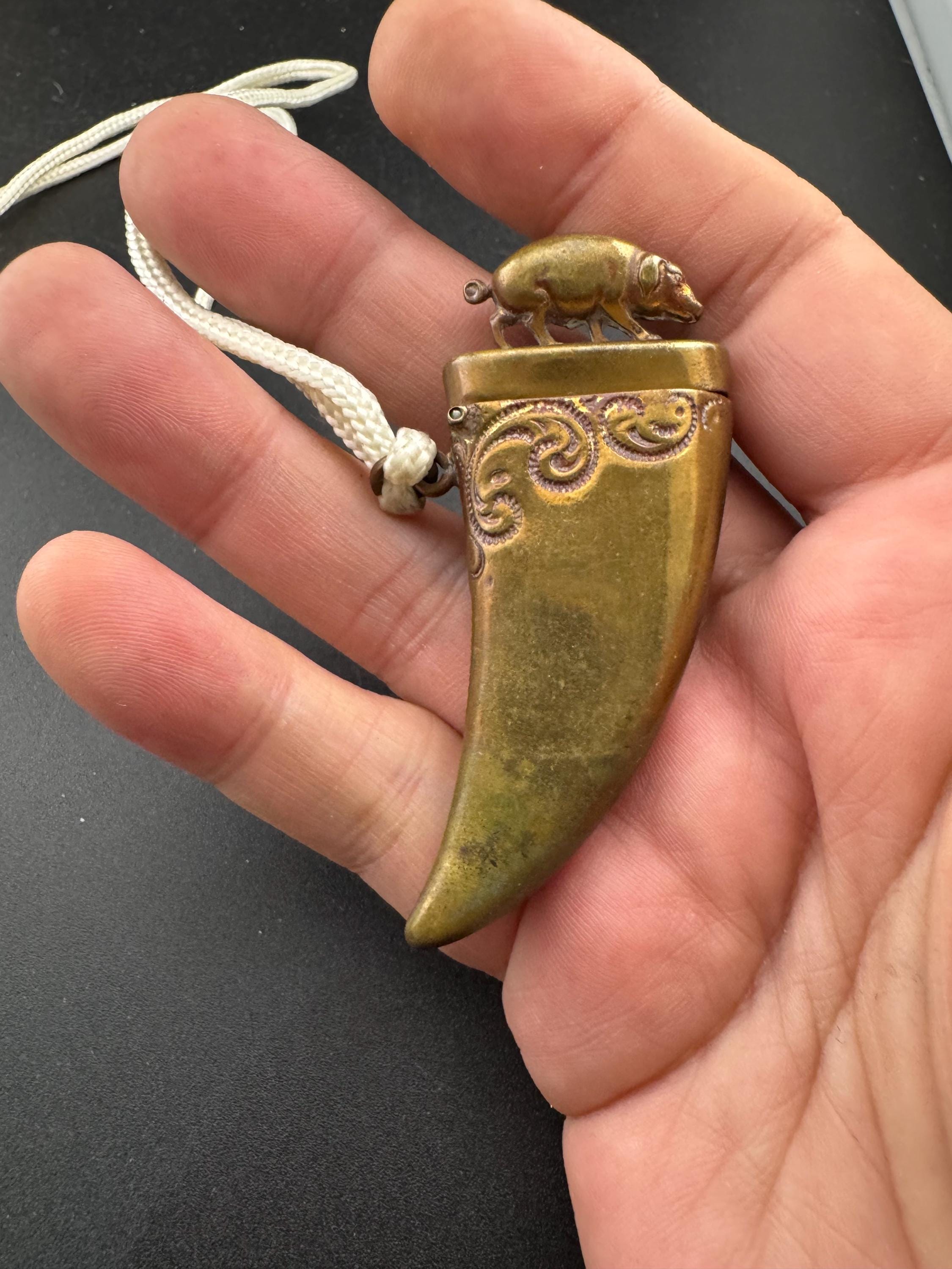 Antique brass novelty match vesta in the form of boar and tusk, antique match vesta case pendant