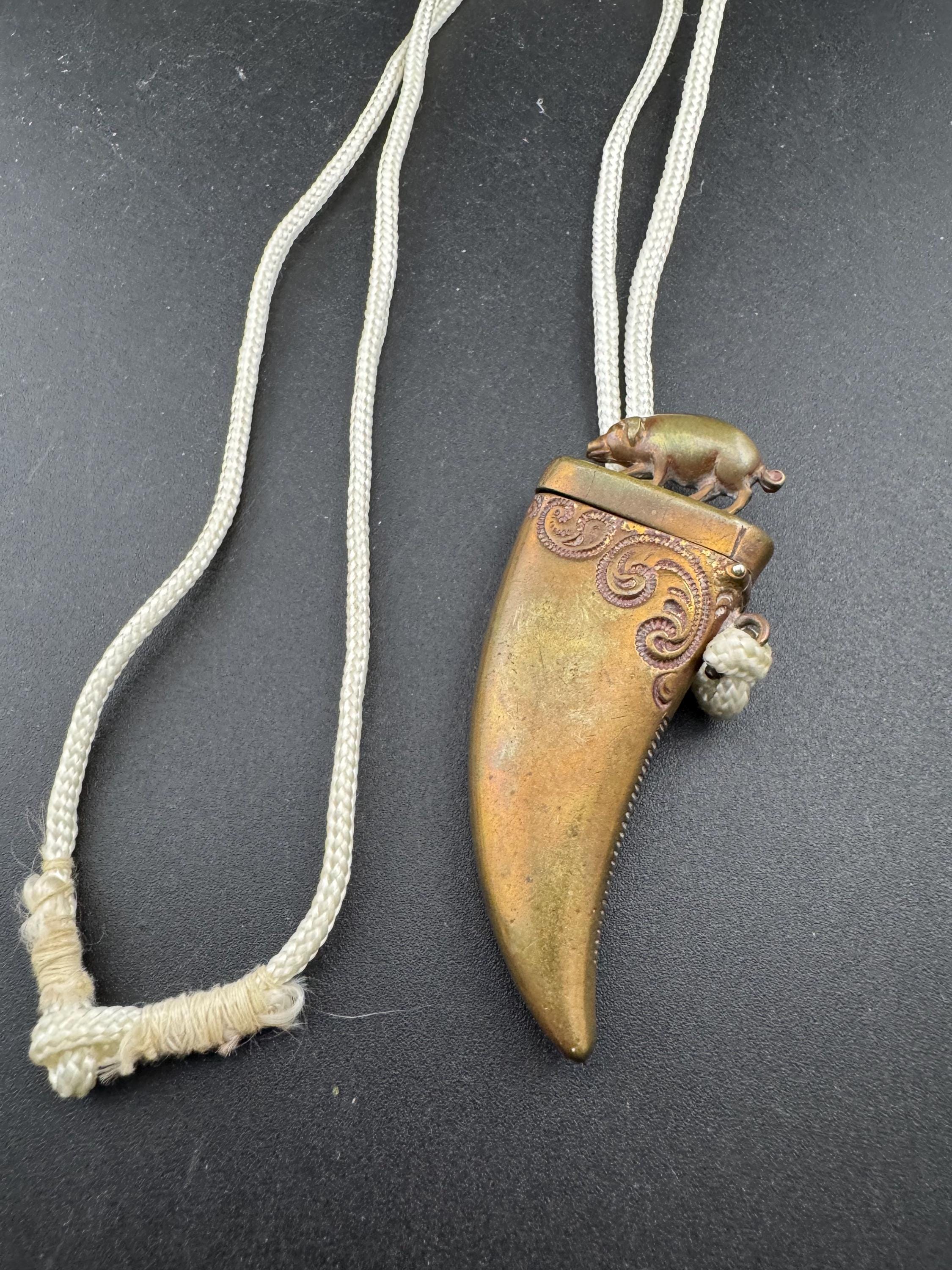 Antique brass novelty match vesta in the form of boar and tusk, antique match vesta case pendant