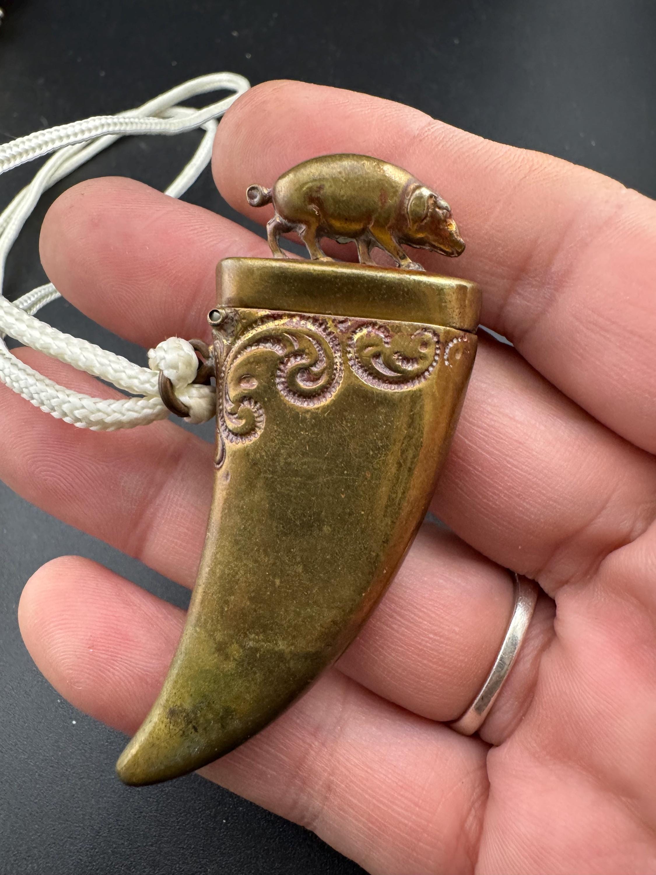 Antique brass novelty match vesta in the form of boar and tusk, antique match vesta case pendant