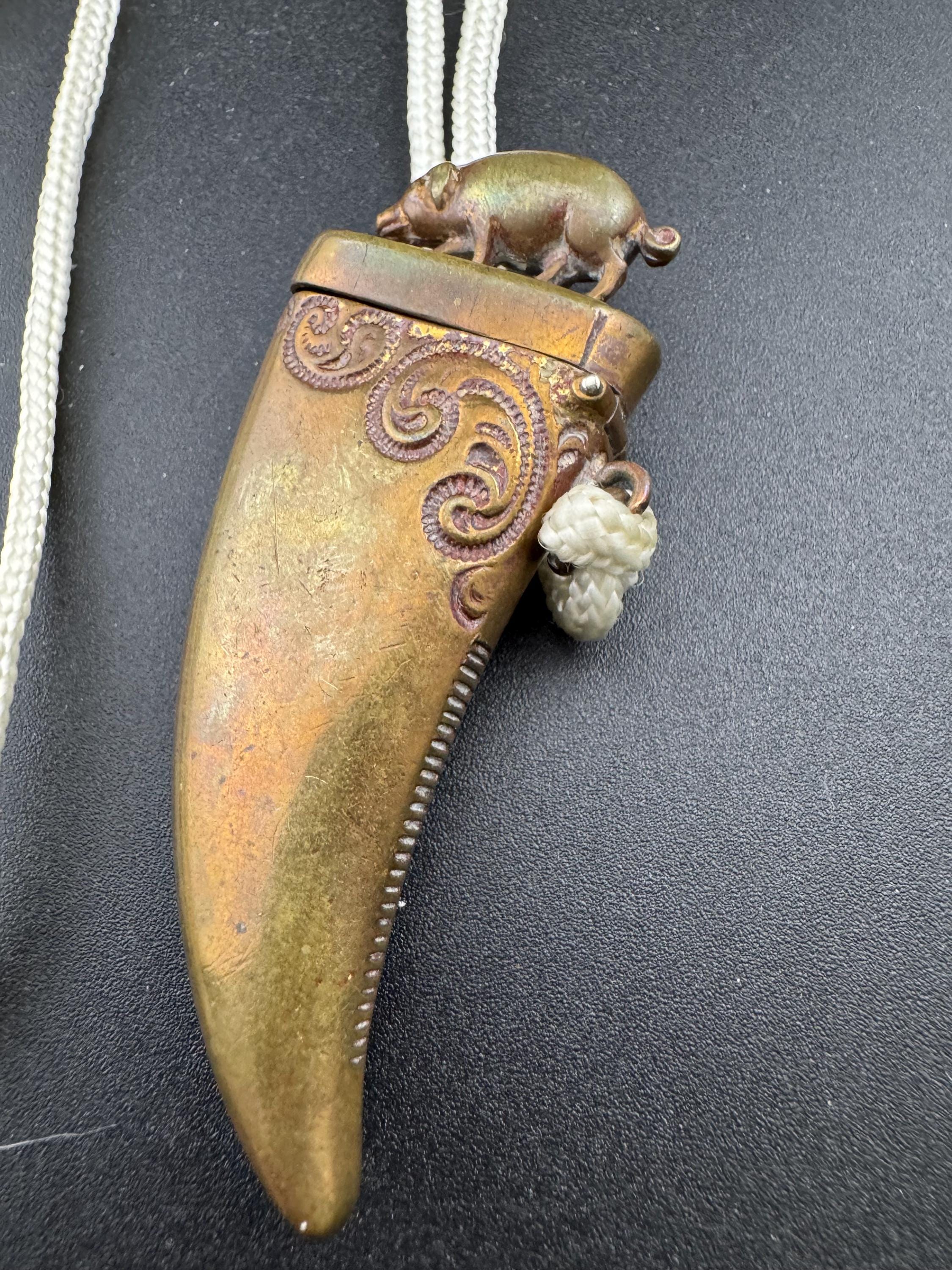 Antique brass novelty match vesta in the form of boar and tusk, antique match vesta case pendant