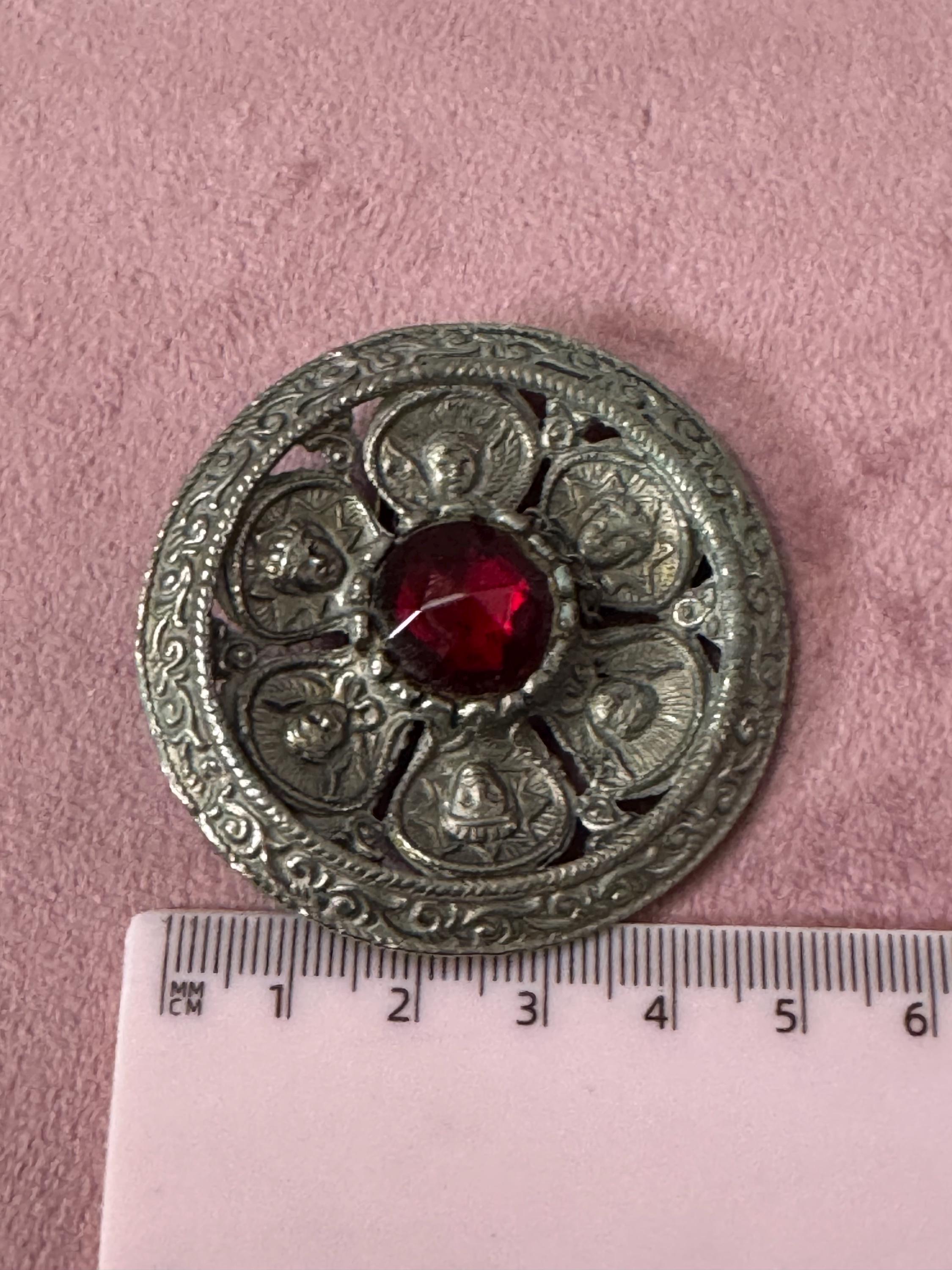 vintage round silver tone Etruscan figural faces large medallion shield brooch set with ruby faceted cabochon