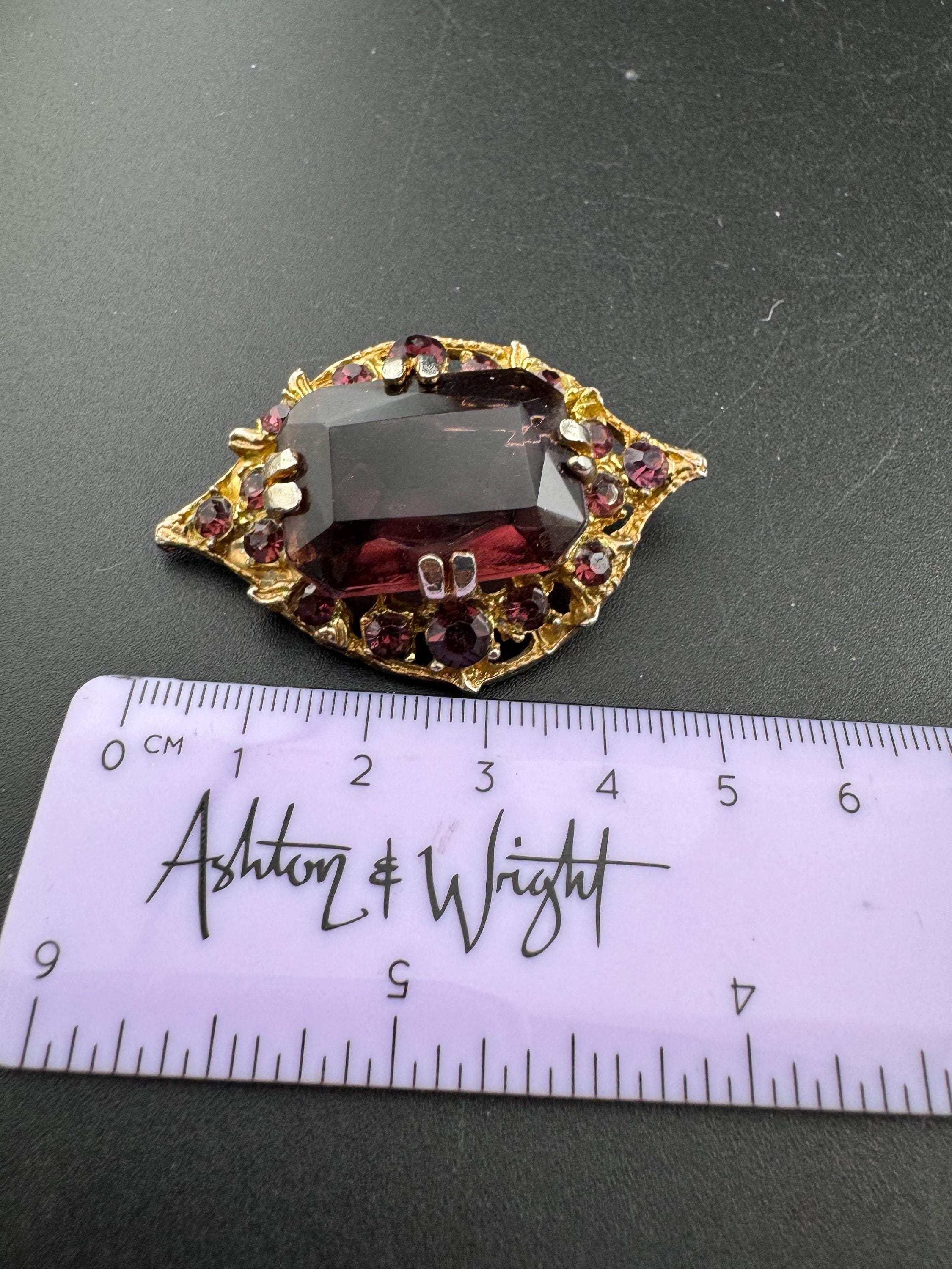 Chunky gold metal brooch with amethyst purple big central rhinestone glass diamanté cabochon