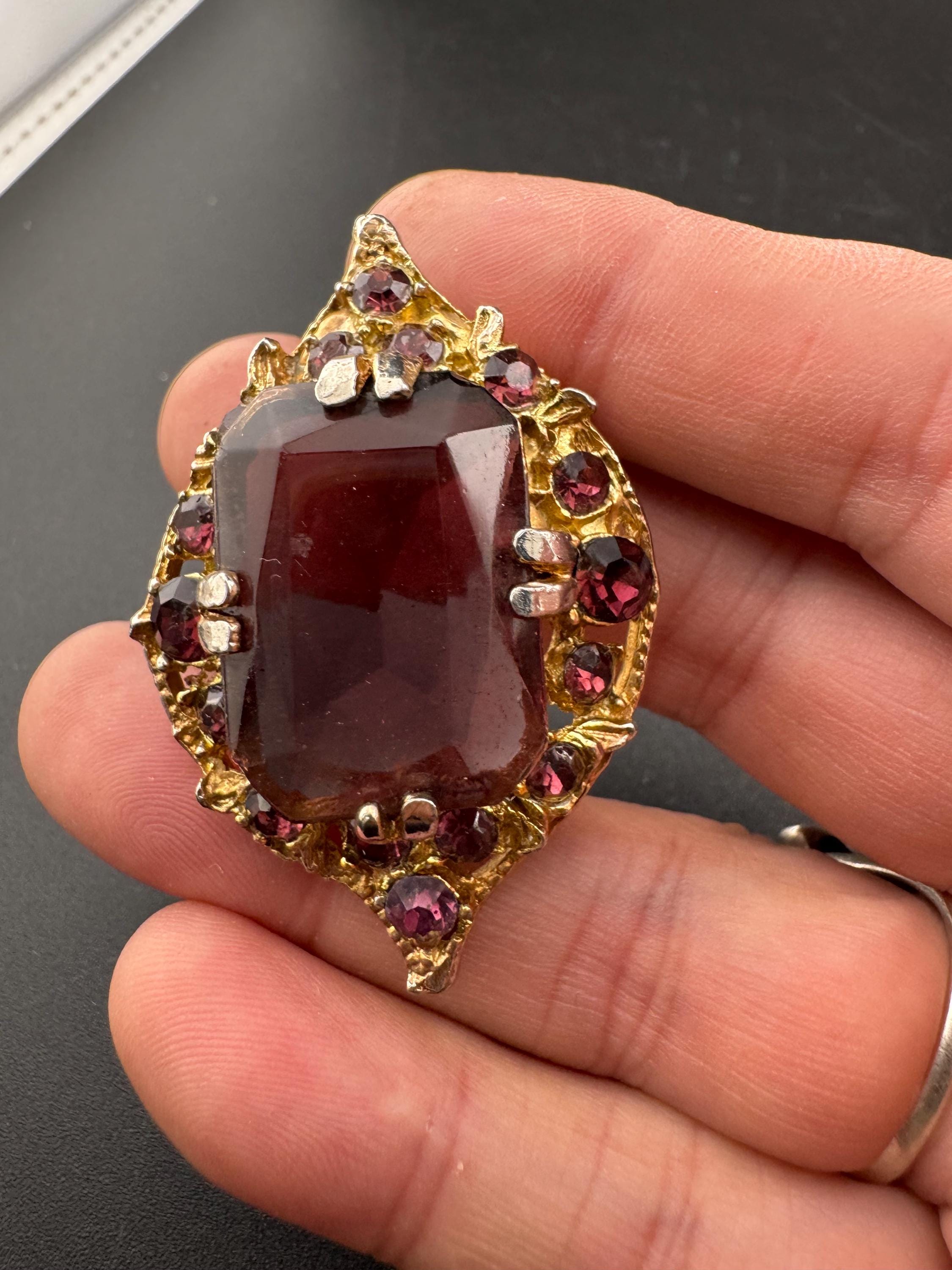 Chunky gold metal brooch with amethyst purple big central rhinestone glass diamanté cabochon