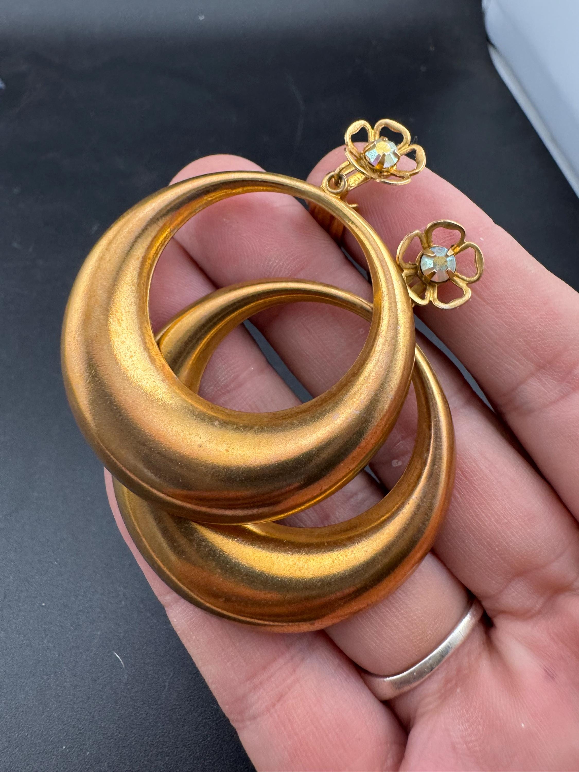 Vintage 1960s brass gold tone big loop clip on earrings set with aurora borealis rhinestone.