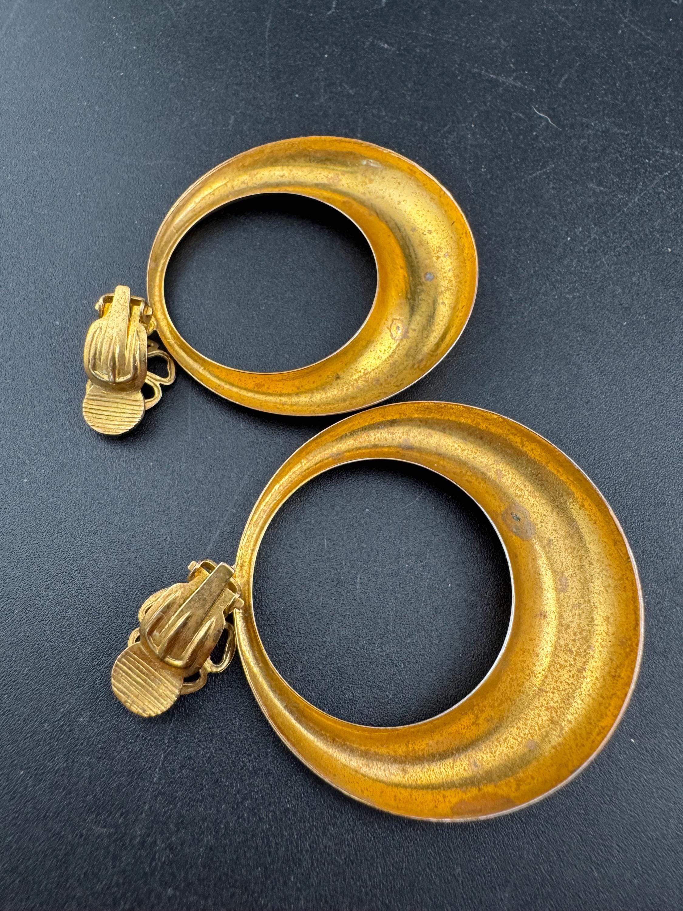Vintage 1960s brass gold tone big loop clip on earrings set with aurora borealis rhinestone.