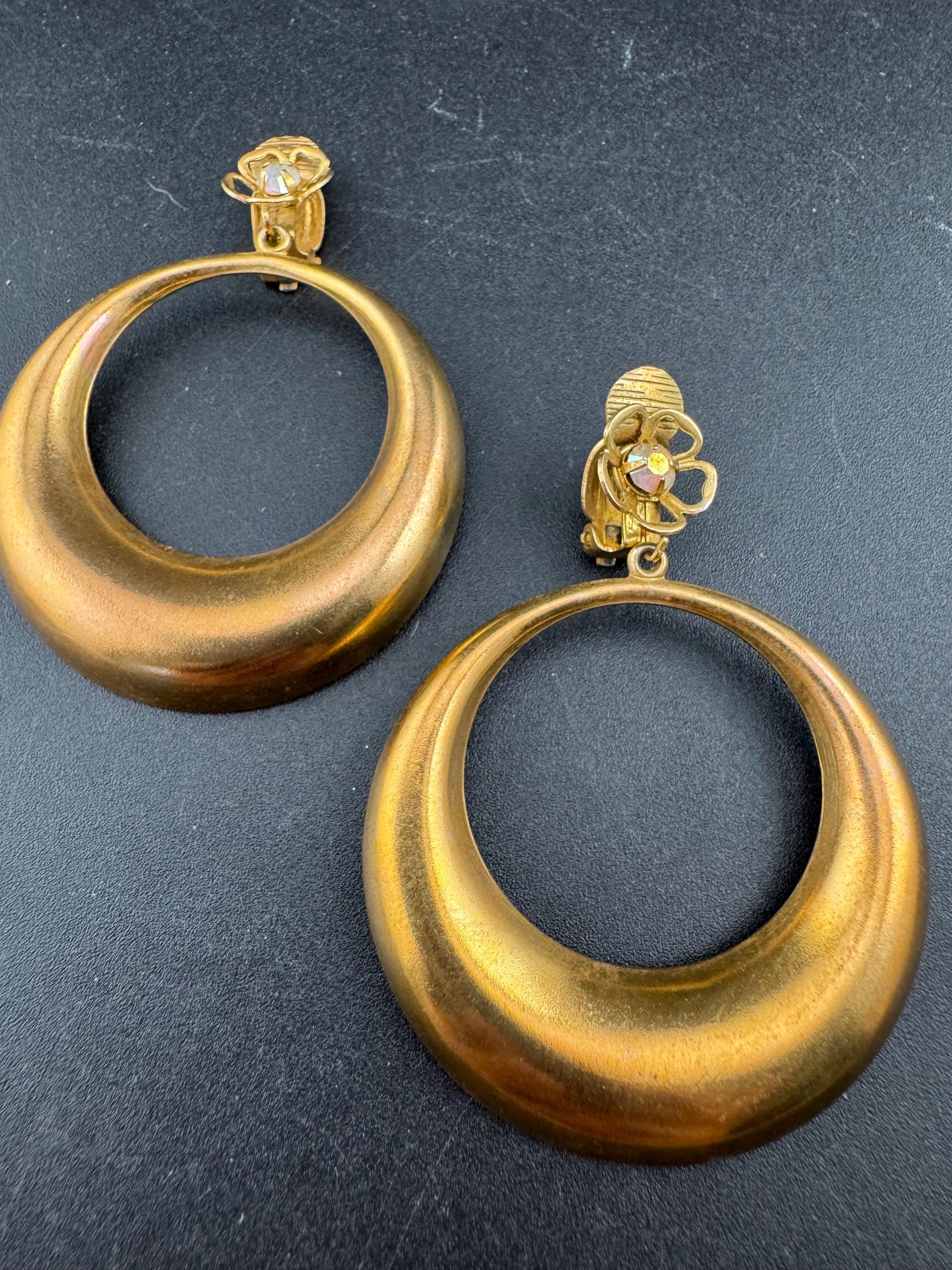 Vintage 1960s brass gold tone big loop clip on earrings set with aurora borealis rhinestone.