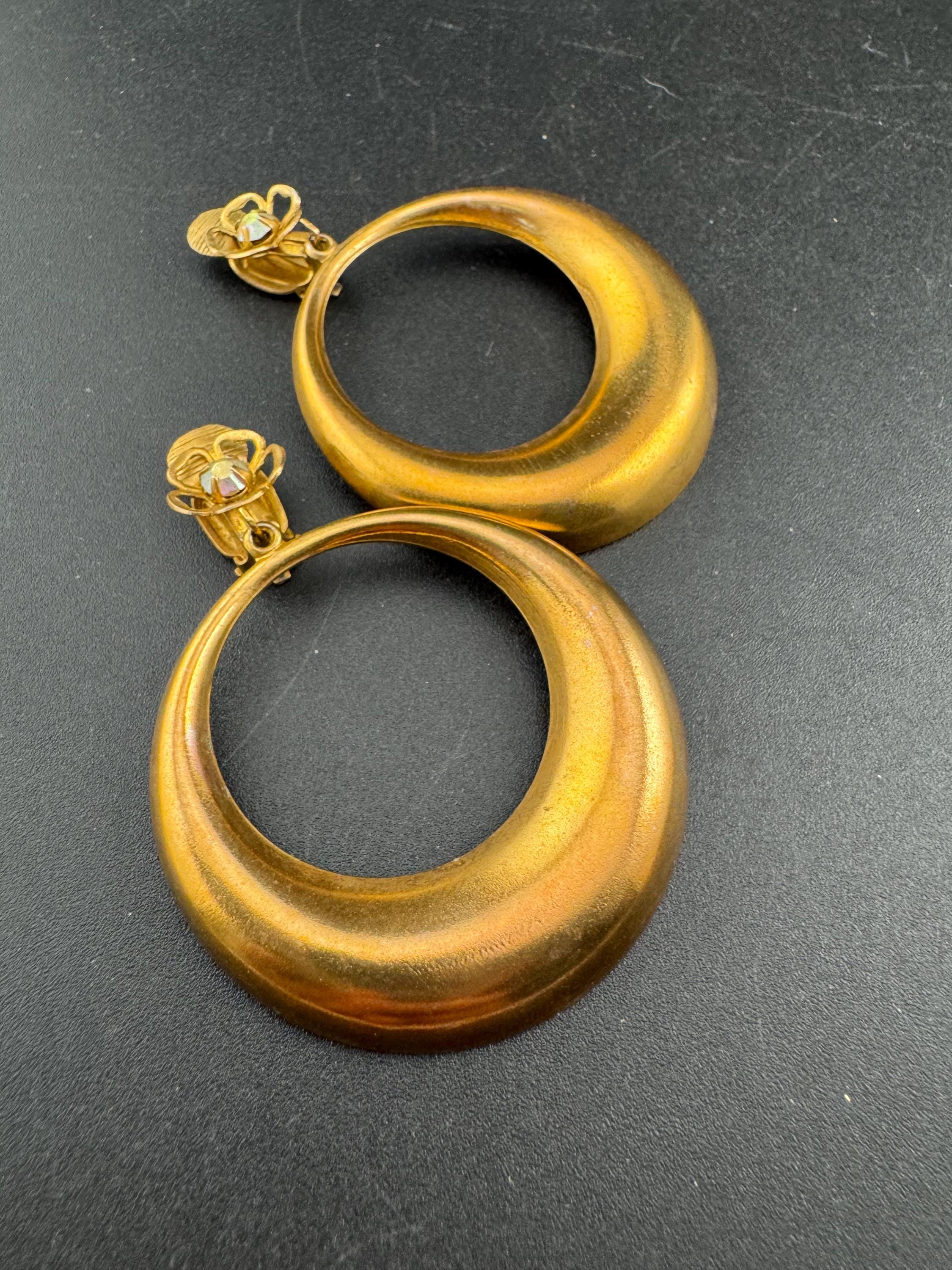 Vintage 1960s brass gold tone big loop clip on earrings set with aurora borealis rhinestone.