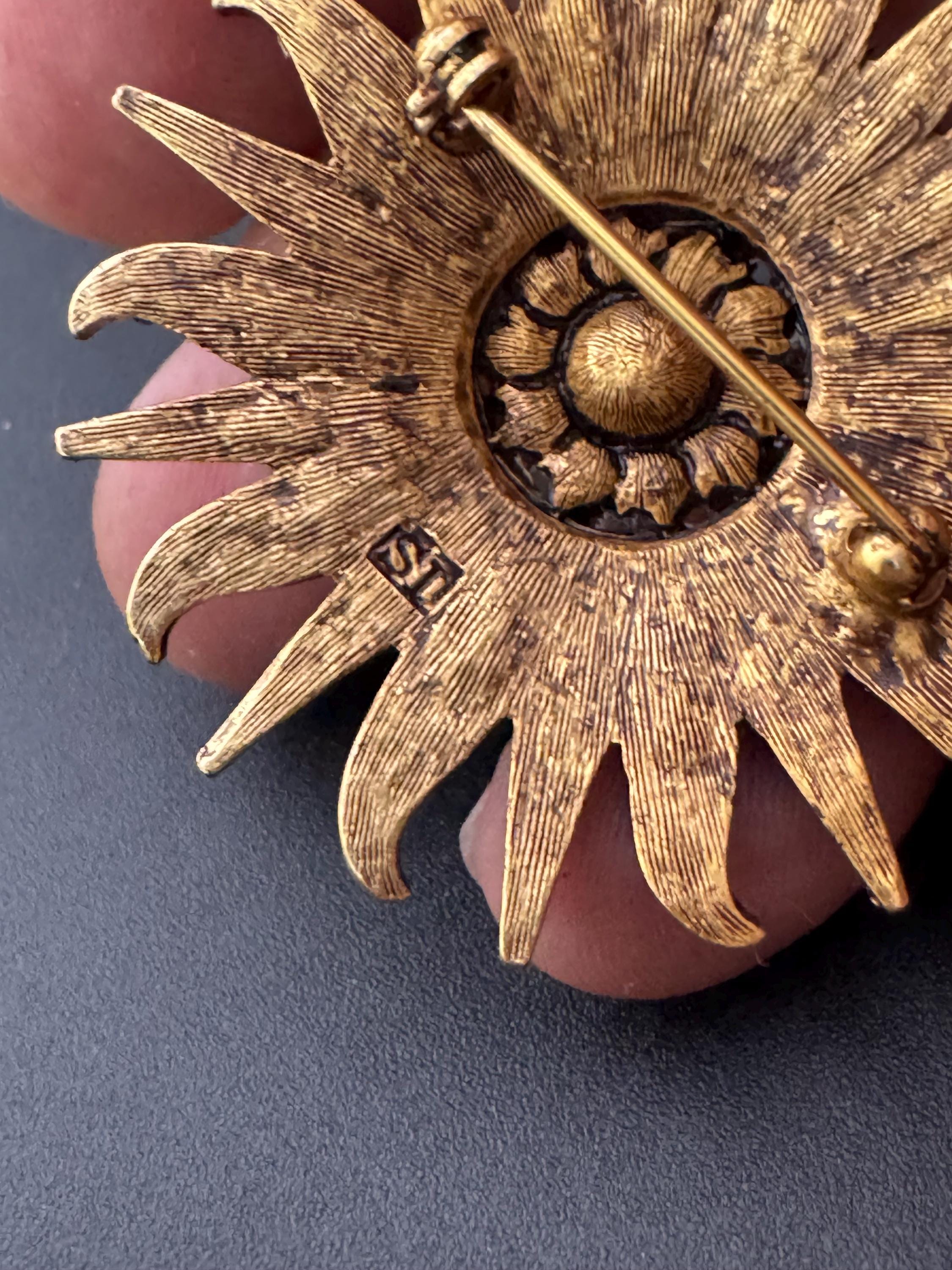 Vintage signed Smithsonian seal brooch. Large gold tone sun set with clear crystals