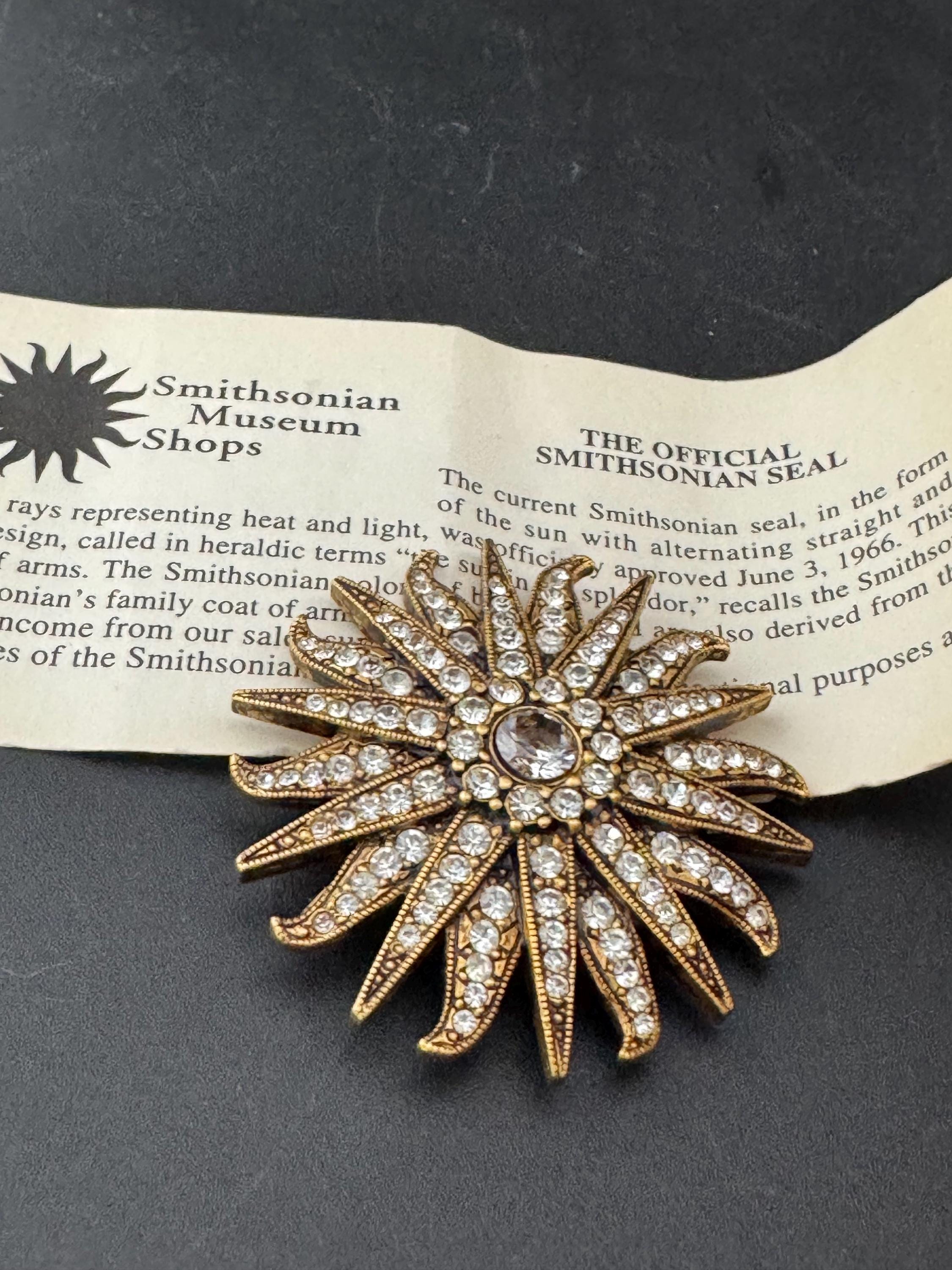 Vintage signed Smithsonian seal brooch. Large gold tone sun set with clear crystals