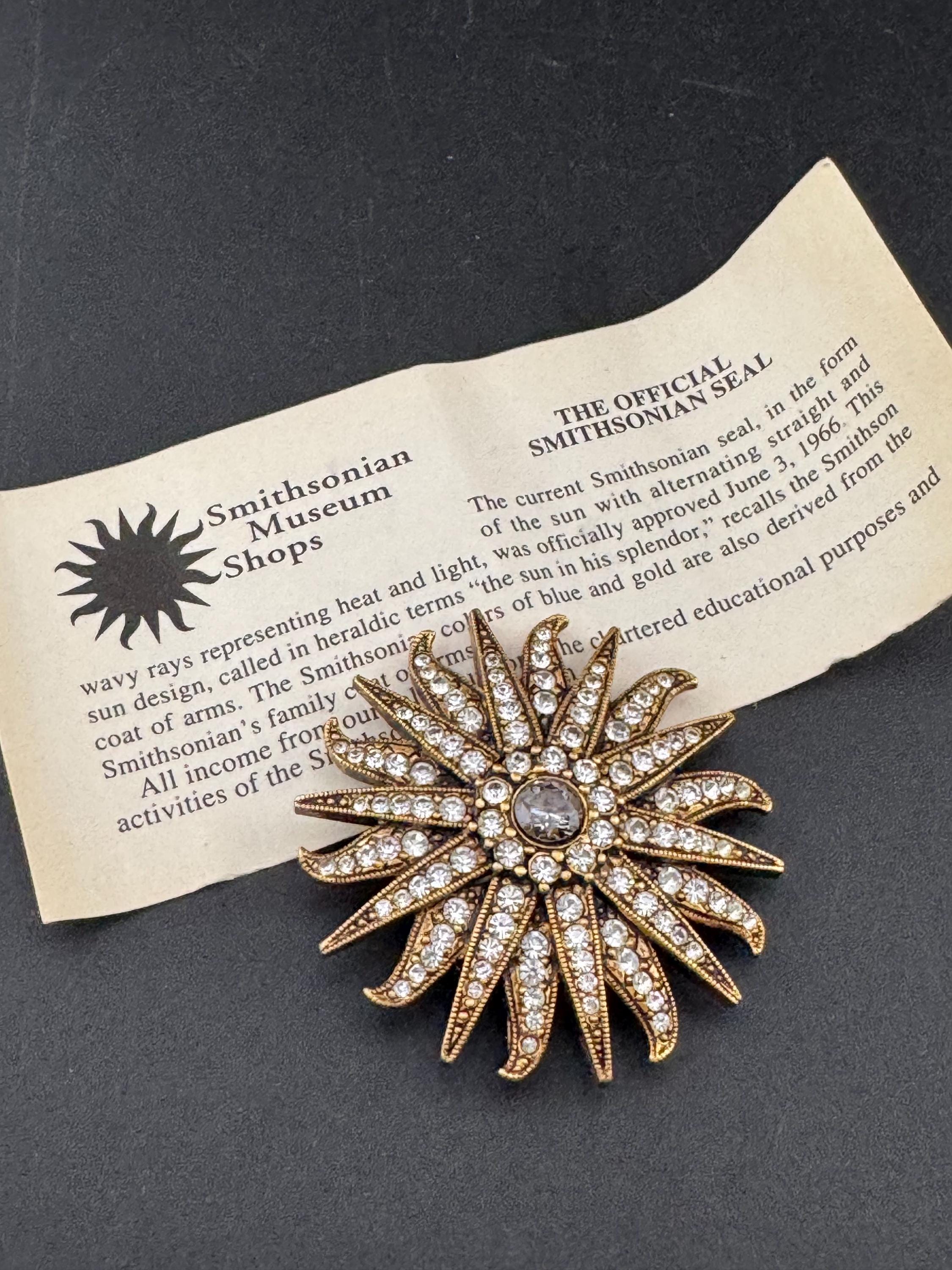 Vintage signed Smithsonian seal brooch. Large gold tone sun set with clear crystals