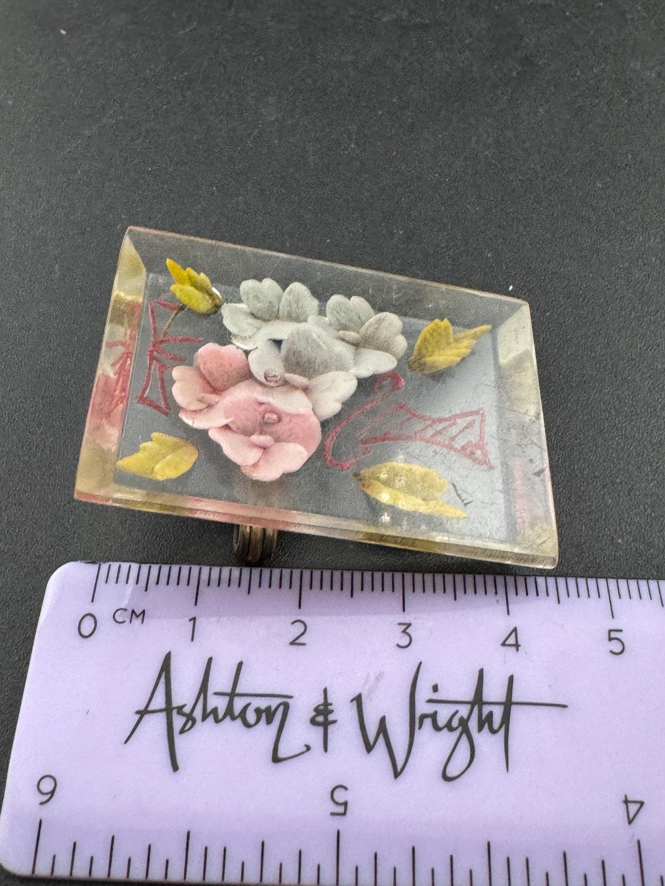 pink floral lucite brooch early plastic pink blue celluloid 1930s Vintage reverse carved