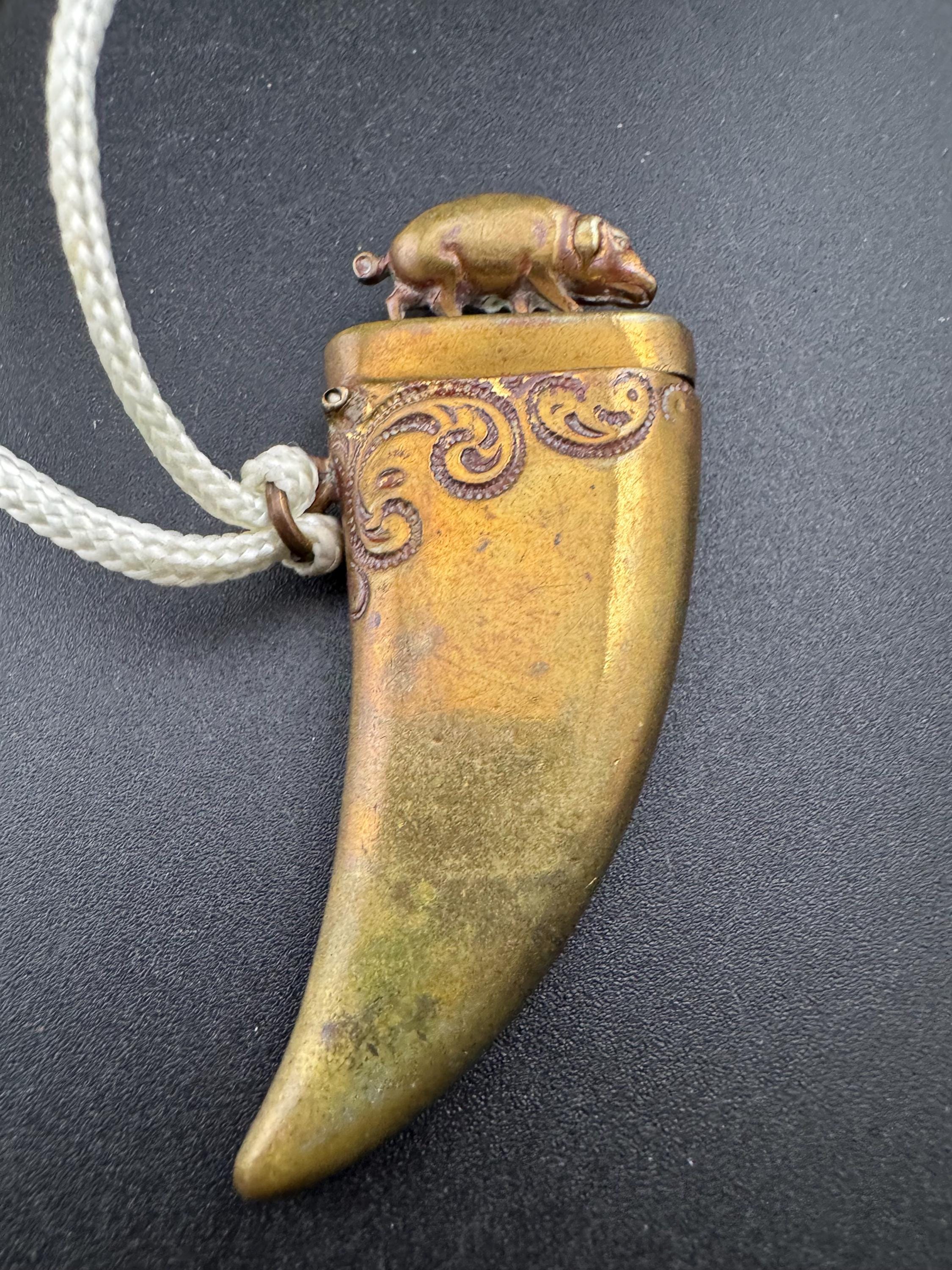 Antique brass novelty match vesta in the form of boar and tusk, antique match vesta case pendant