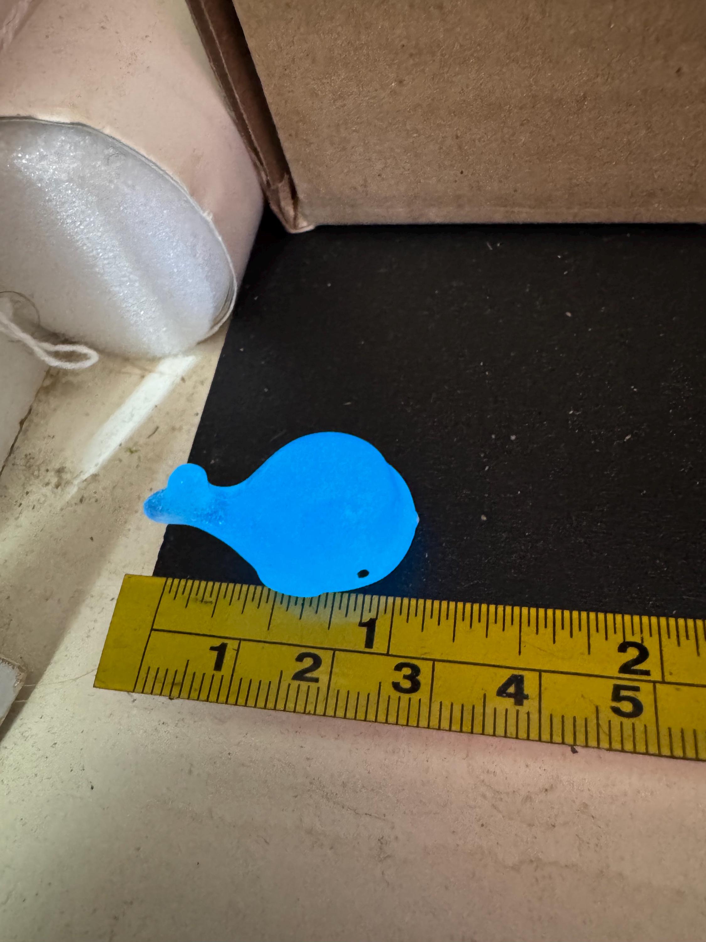 2 pieces of miniature glow in the dark blue sharks seaside cake topper