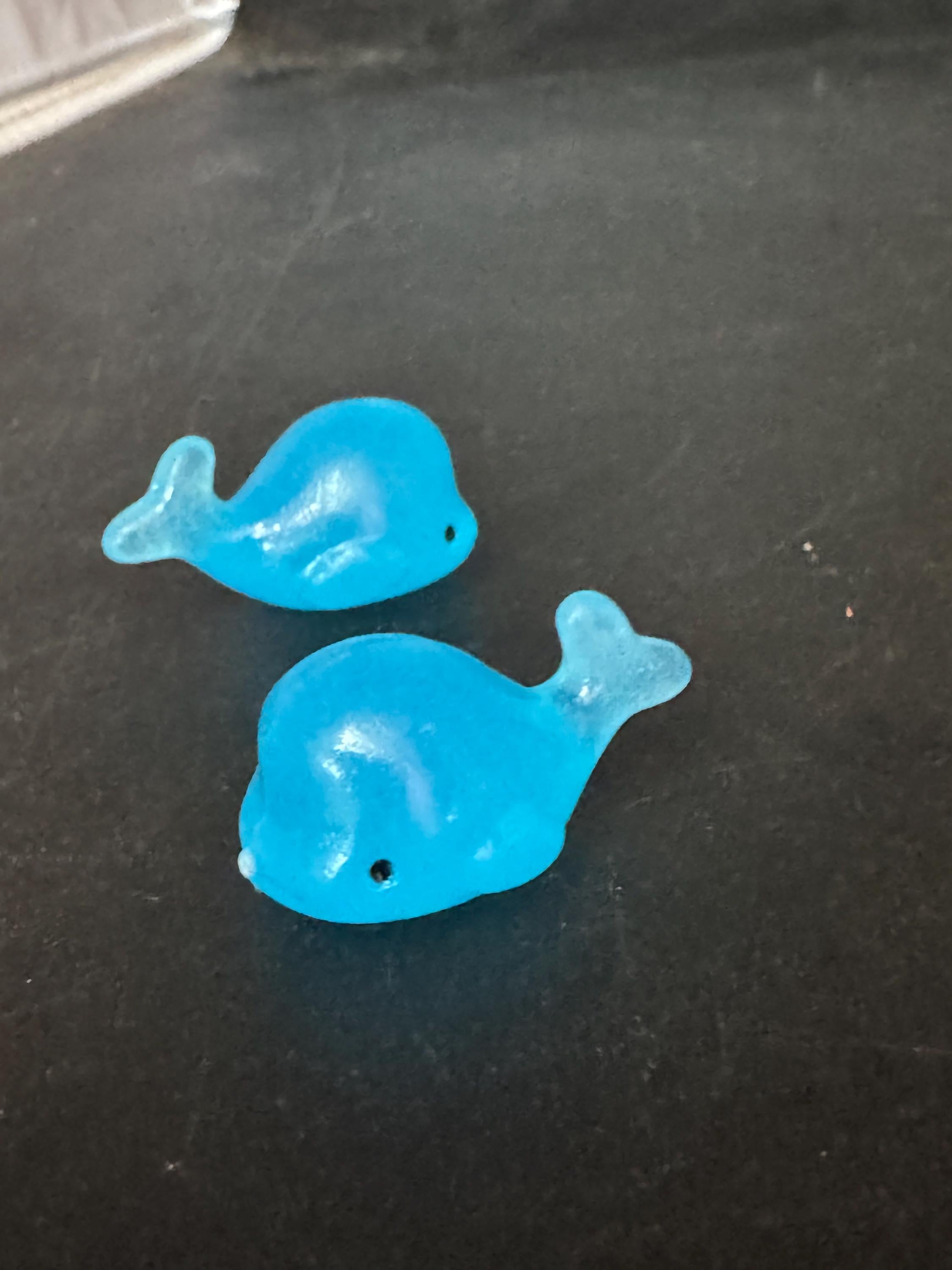 2 pieces of miniature glow in the dark blue sharks seaside cake topper
