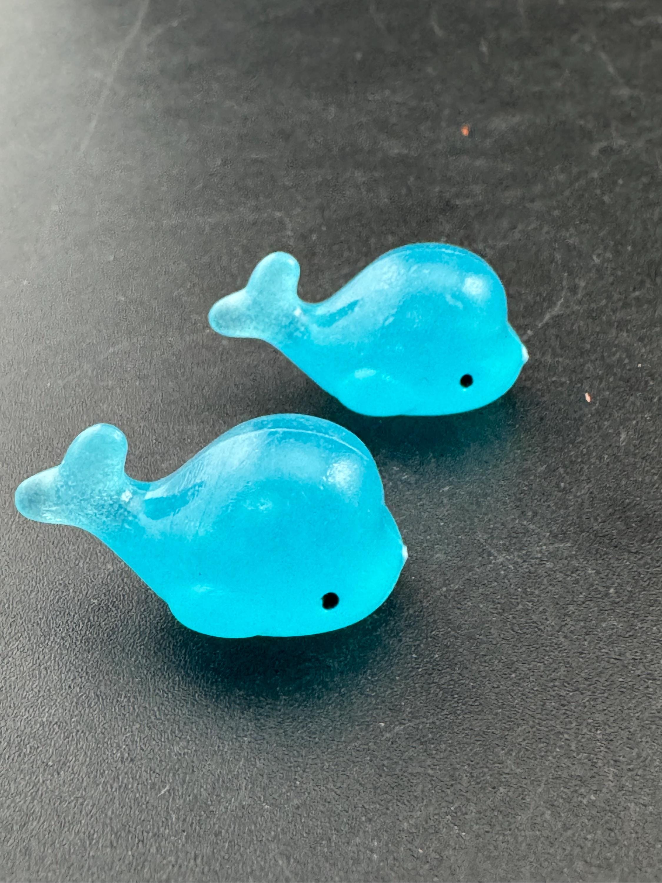 2 pieces of miniature glow in the dark blue sharks seaside cake topper